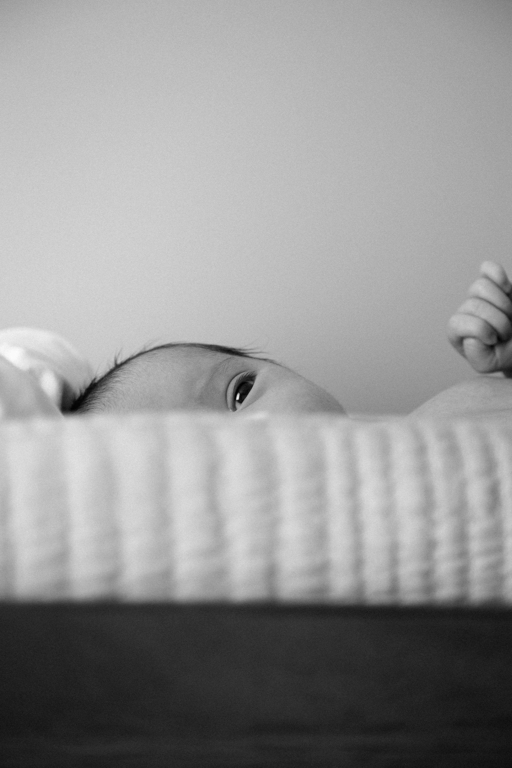 black and white image of an infant laying down