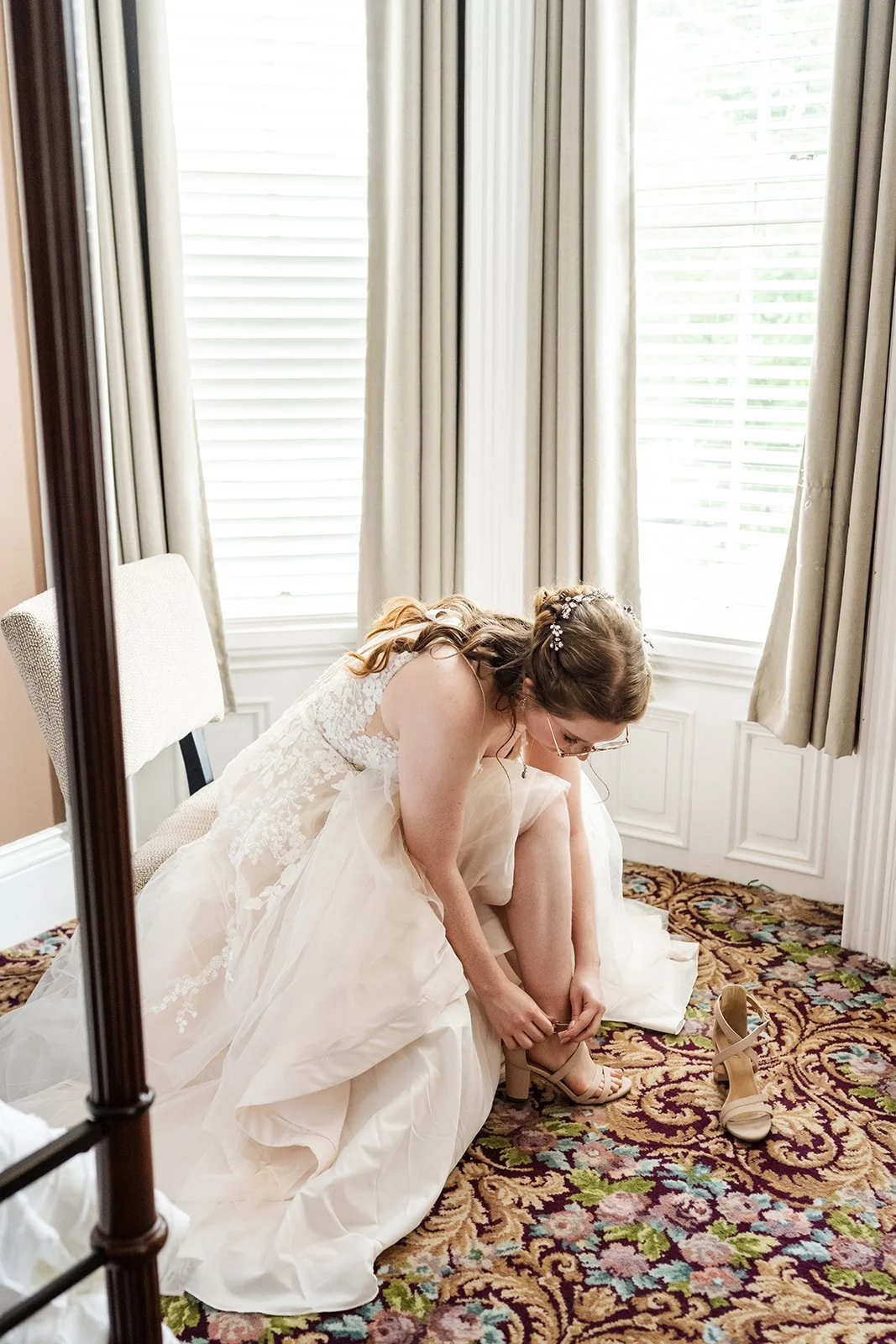 Bride putting on her wedding shoes