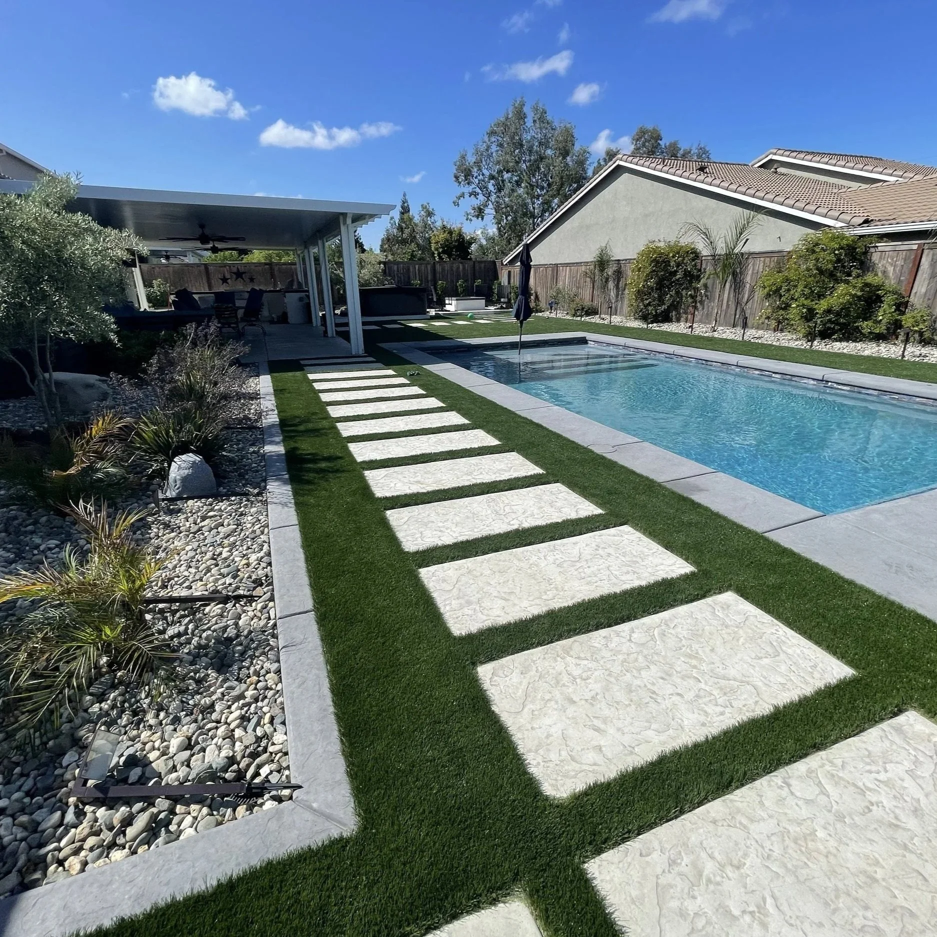 Stamped concrete steps with artificial turf in the gaps