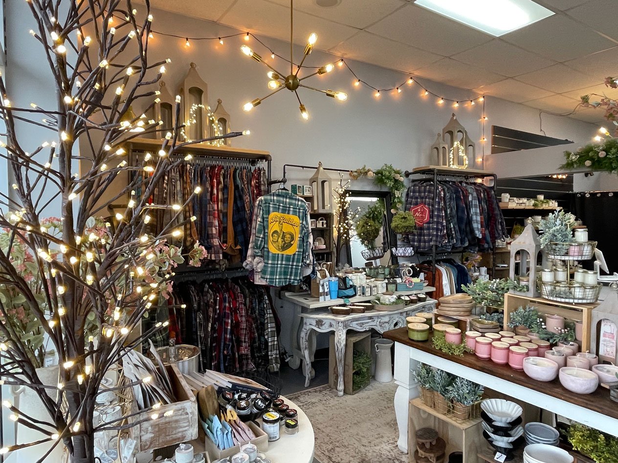 Inside Good Finds by Dandles with flannel shirts from Second Season and candles from Dandles Candles.