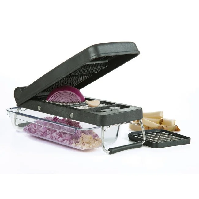 A black food chopper with a transparent storage container underneath, containing chopped onions and garlic, with sliced onions and garlic.