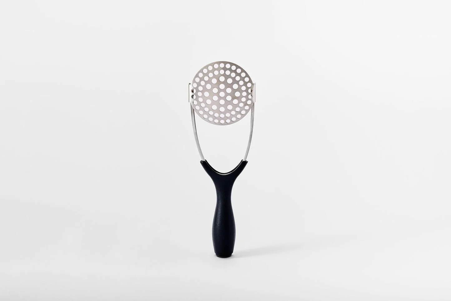 A metal potato masher that flips flat.