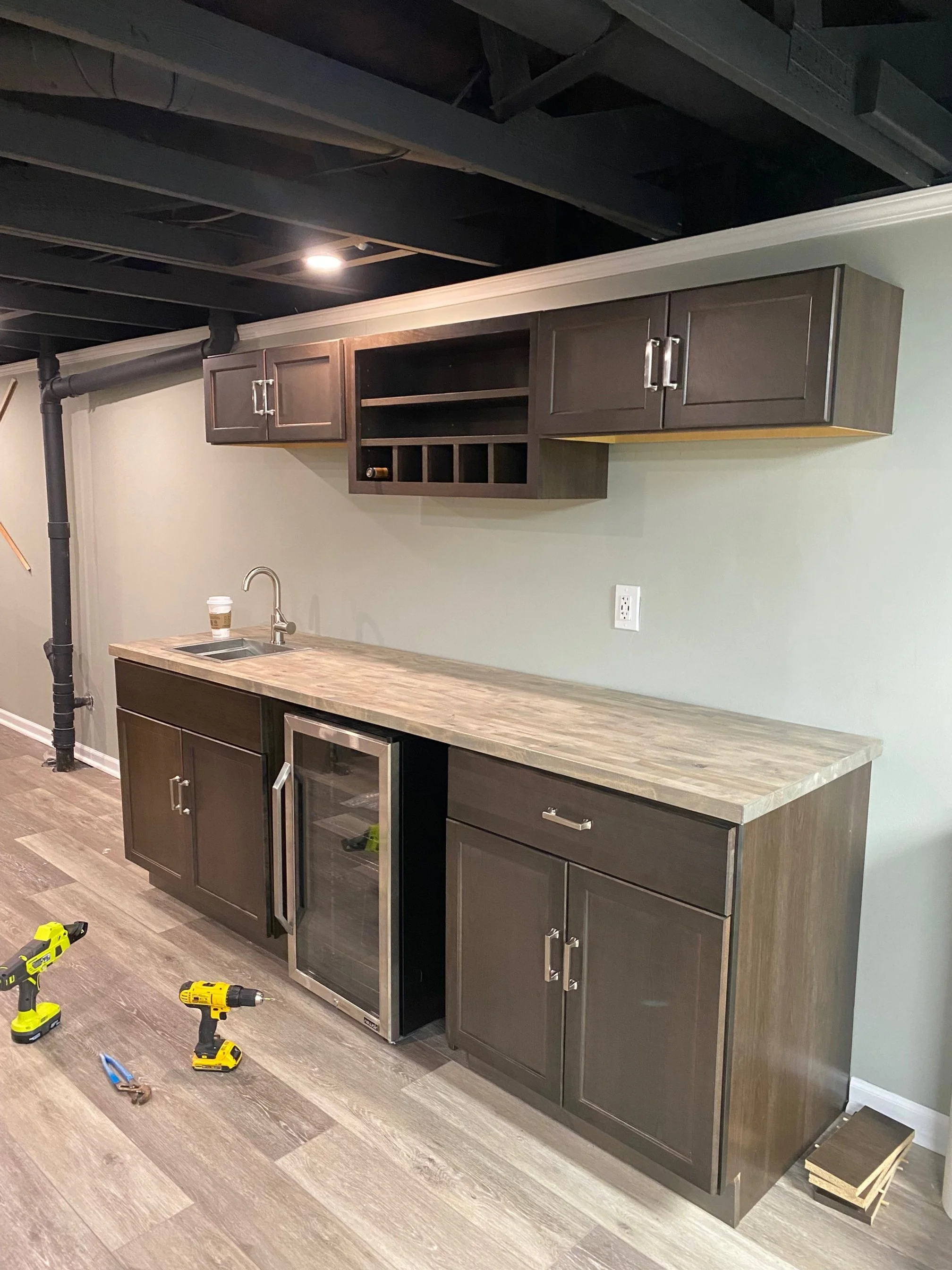 countertop with sink and cabinets. Wet bar