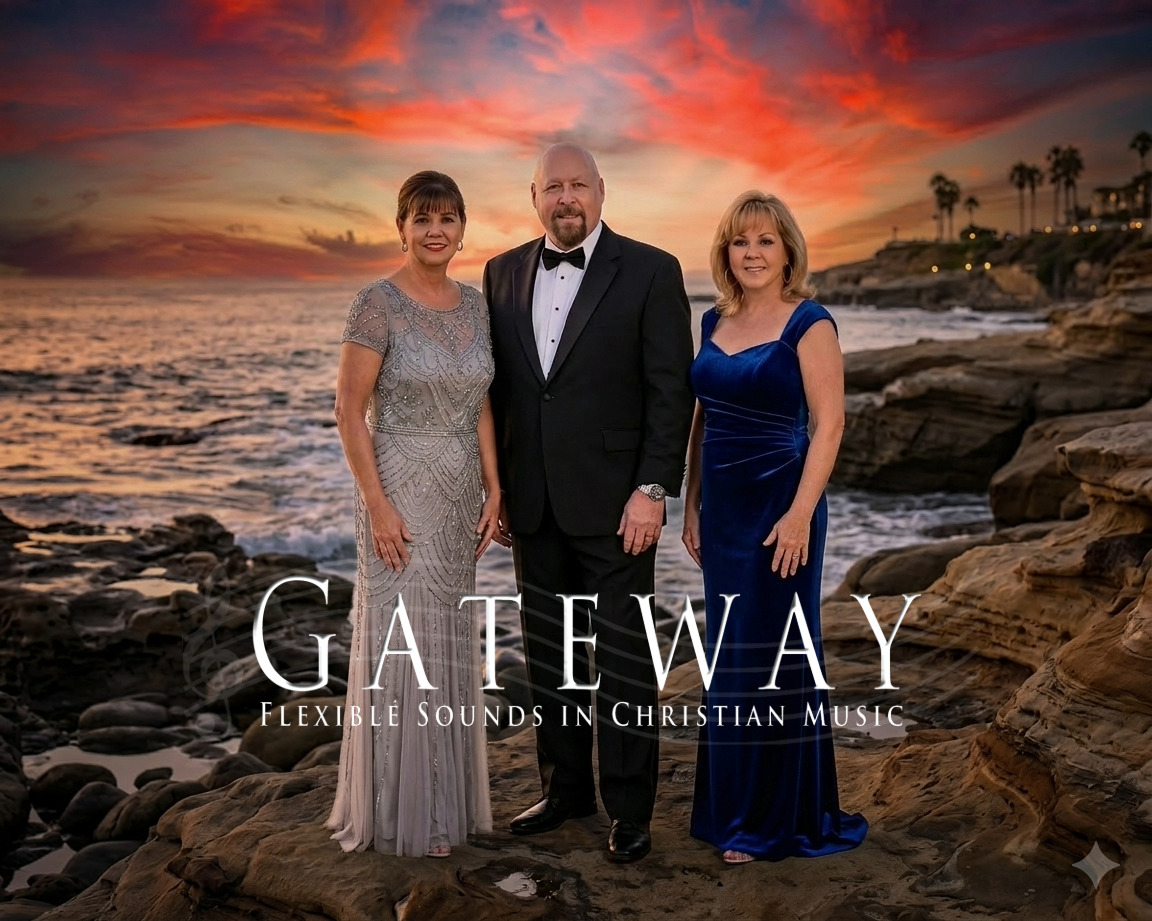 Three people dressed formally standing on a rocky beach at sunset, with the ocean in the background. The woman on the left is wearing a silver beaded gown, the man in the middle is in a black tuxedo, and the woman on the right is in a royal blue gown