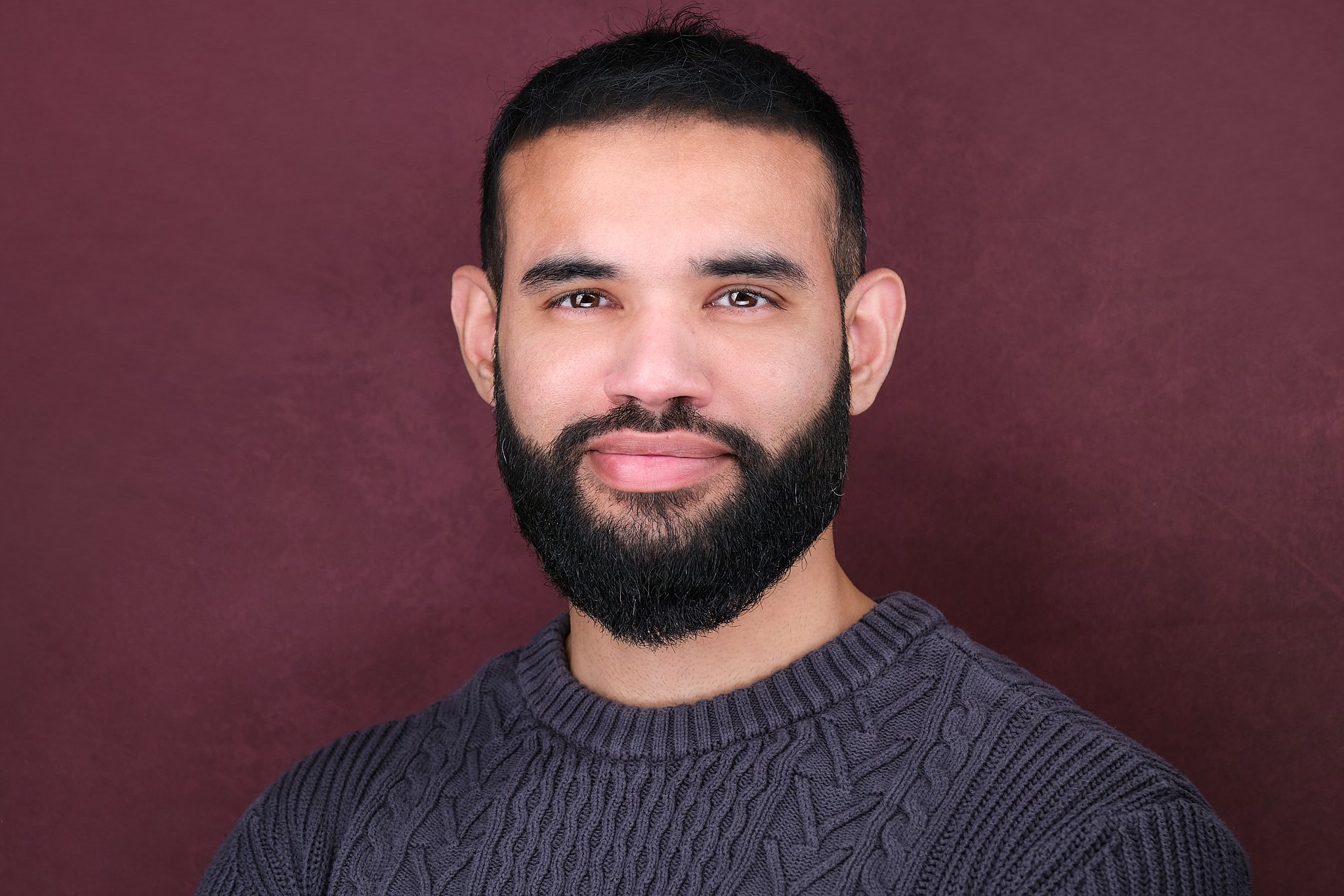 Ghulam Ahmad Headshot March 202600505-Sweater and Marron Background.jpg
