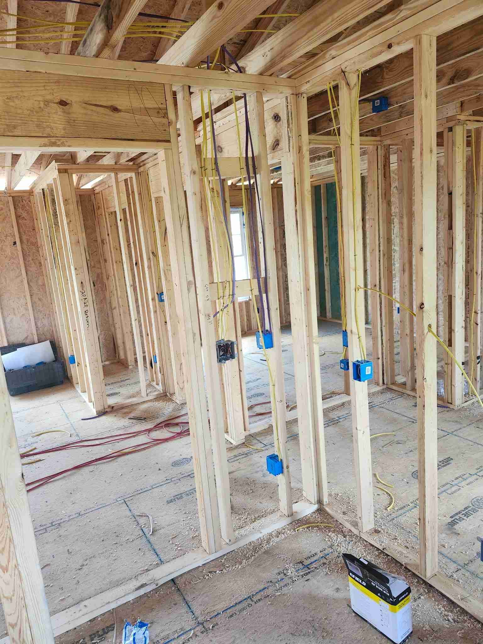 New electrical wiring being run through wall studs during a whole-home rewire in Middle Tennessee