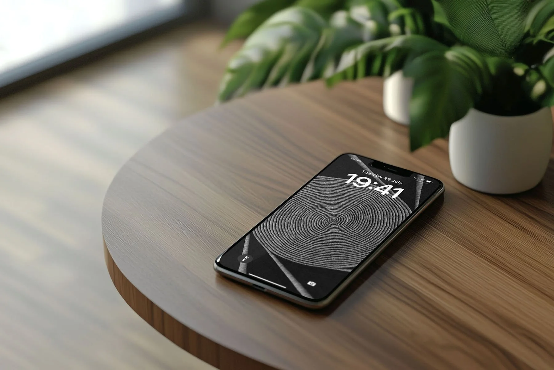 Iphone-with-black-and-white-line-art-wallpaper-and-lockscree- laying-on-wooden-table-and-pot-plants-in-background