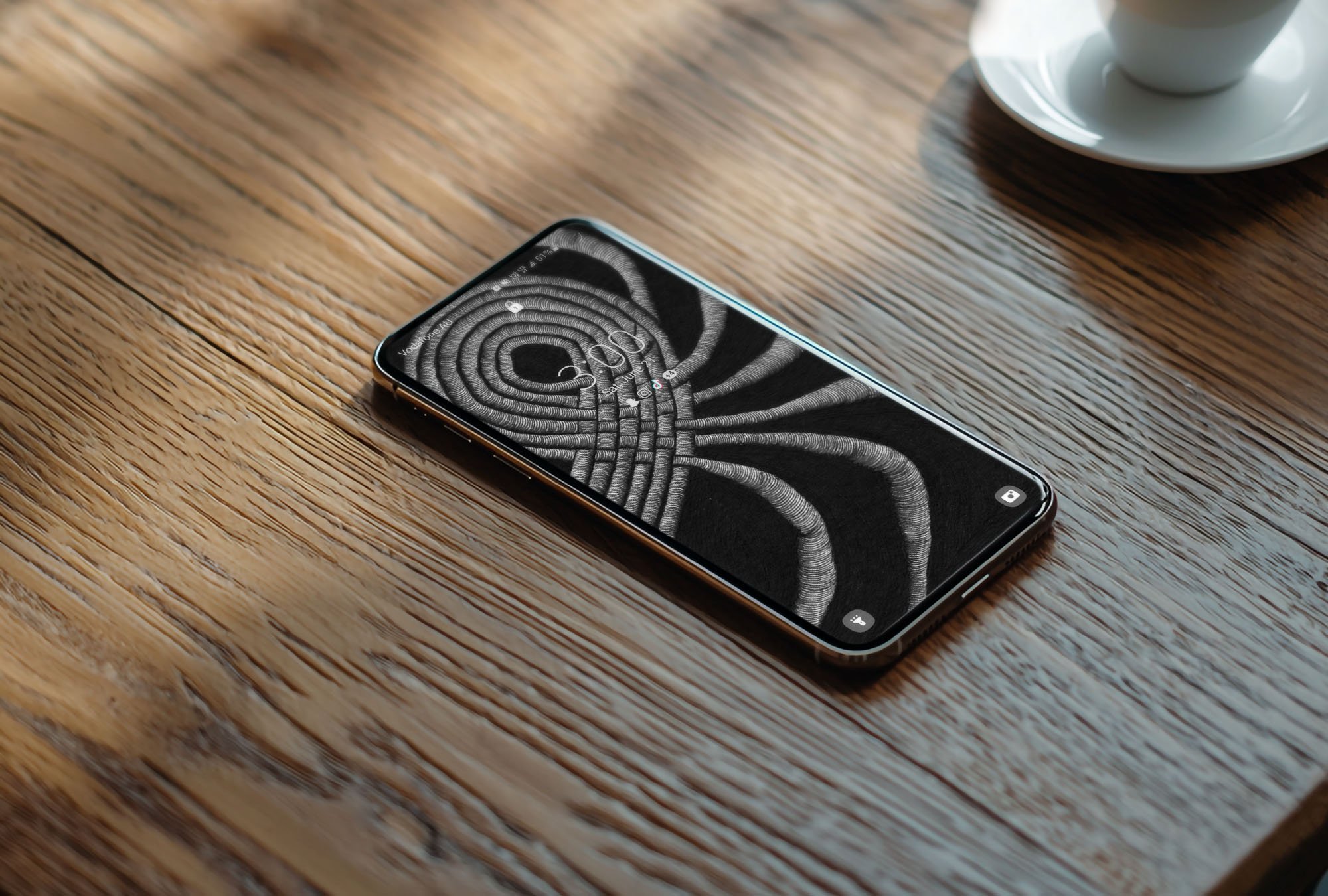 Android-phone-sitting-on-grainy-wooden-coffee-table-with-unconscious-flow-line-art-wallpaper-with-lock-screen.jpg