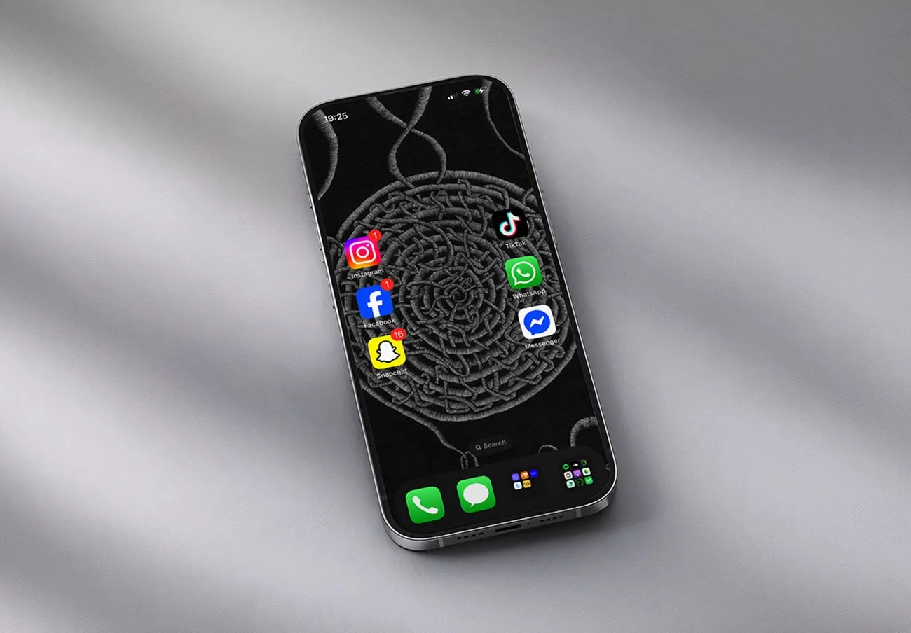 Iphone-with black-and-white line-art-wallpaper-with-homescreen-and-app-icons-laying-on-a-white-surface-with-shadow.jpg