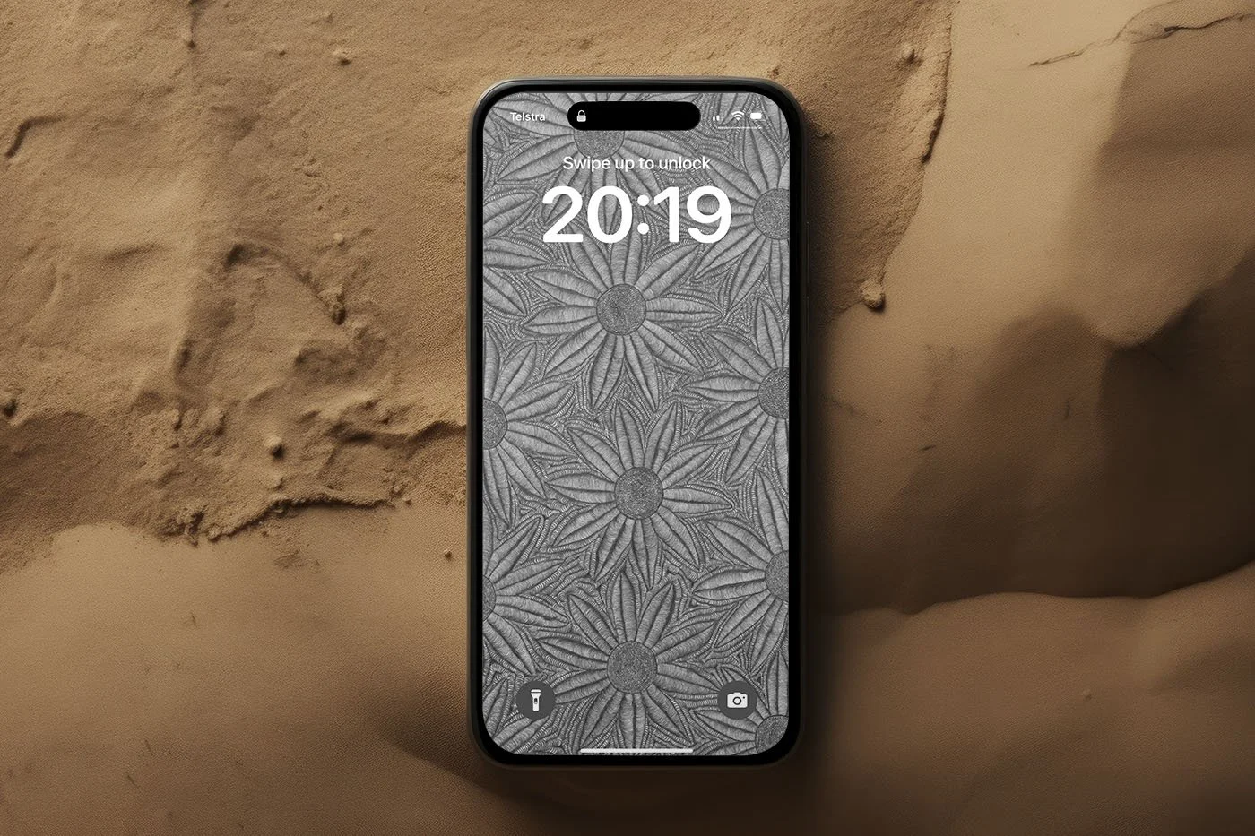 Iphone-with-black-and-white-line-art-wallpaper-laying-in-dessert-sand.jpg
