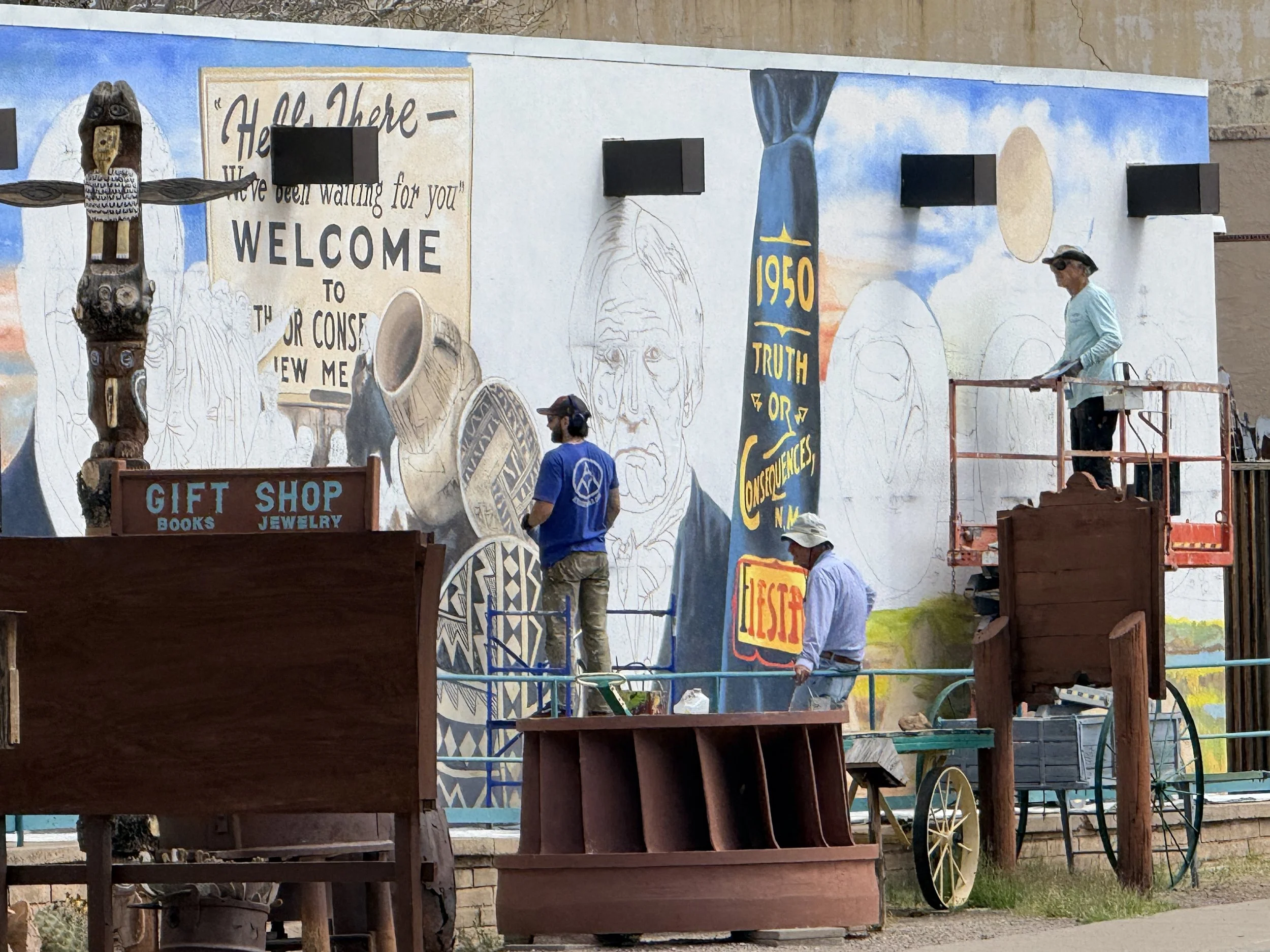 A fun photo of a mural being painted by the artist. 