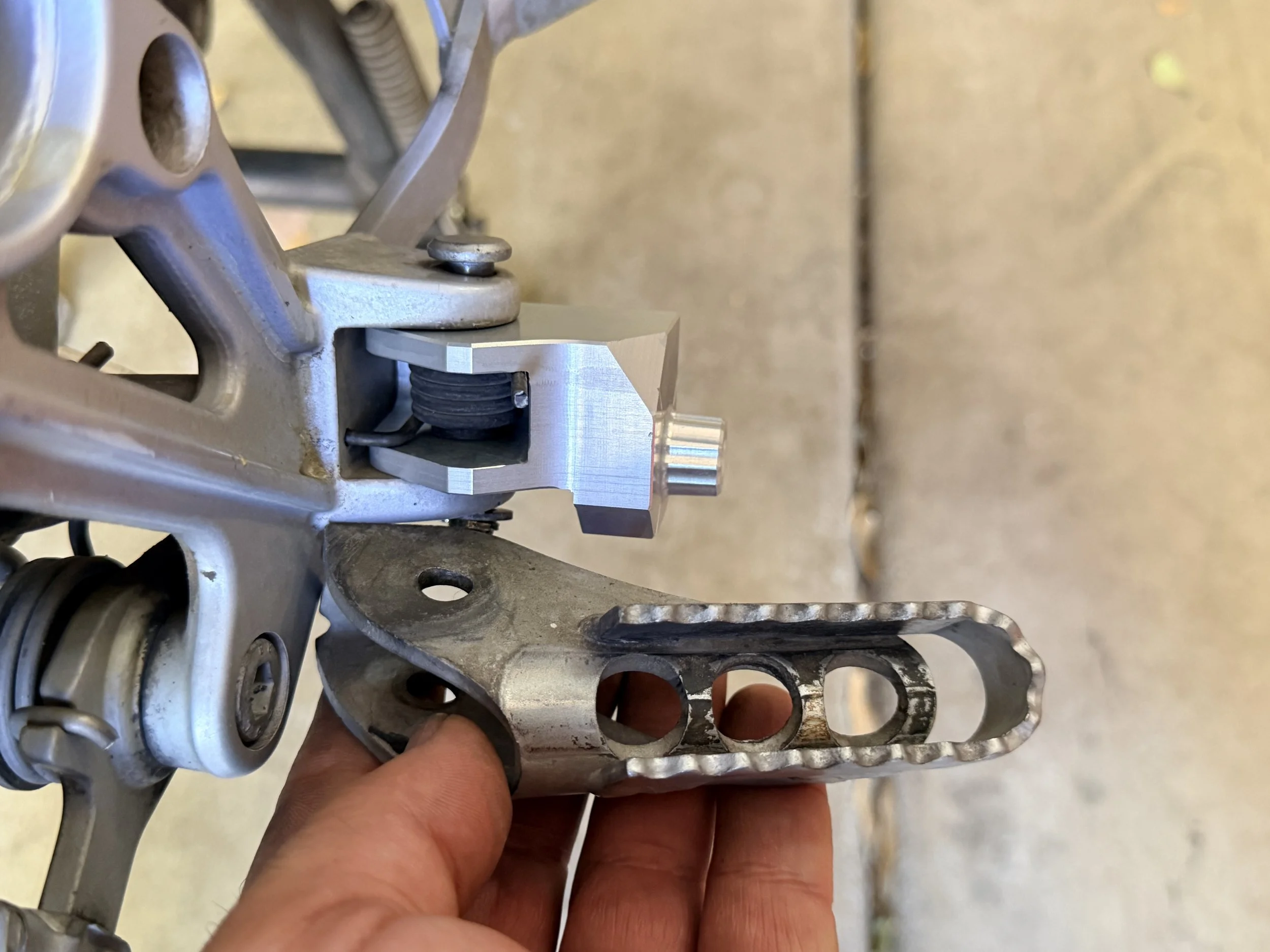 Swapping out stock pegs for SW-Motech pegs. 