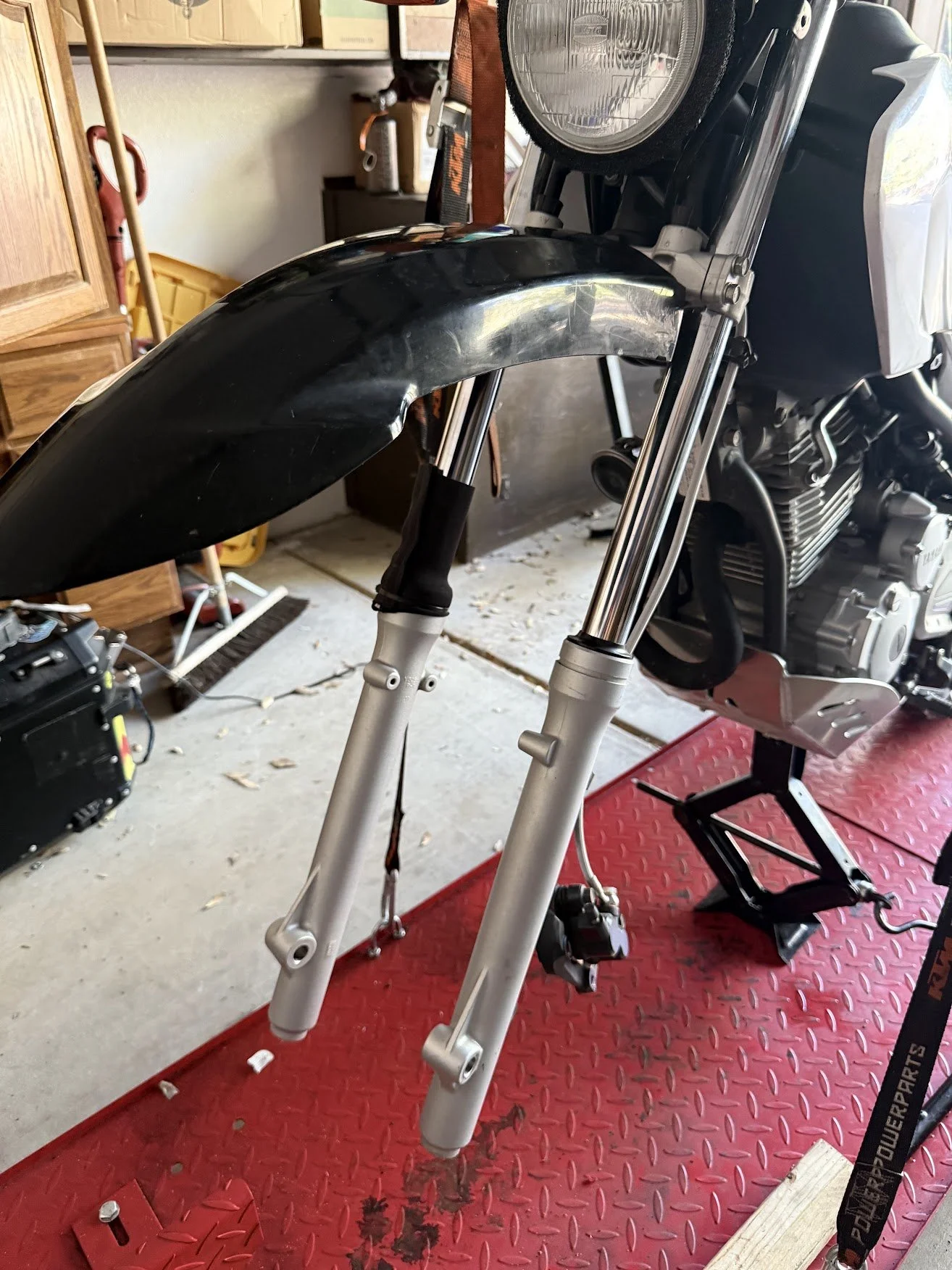 First the fork boots - took off the shocks, repurposed them for the BMW R1250GSA, took the wheel off, and removed the forks. 