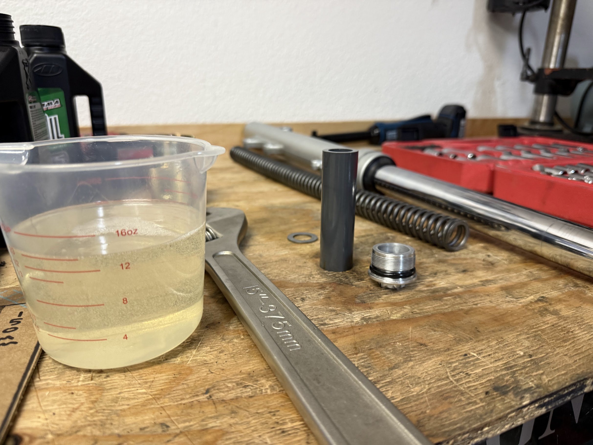 Utilizing the service manual for adding 15W fork oil. 