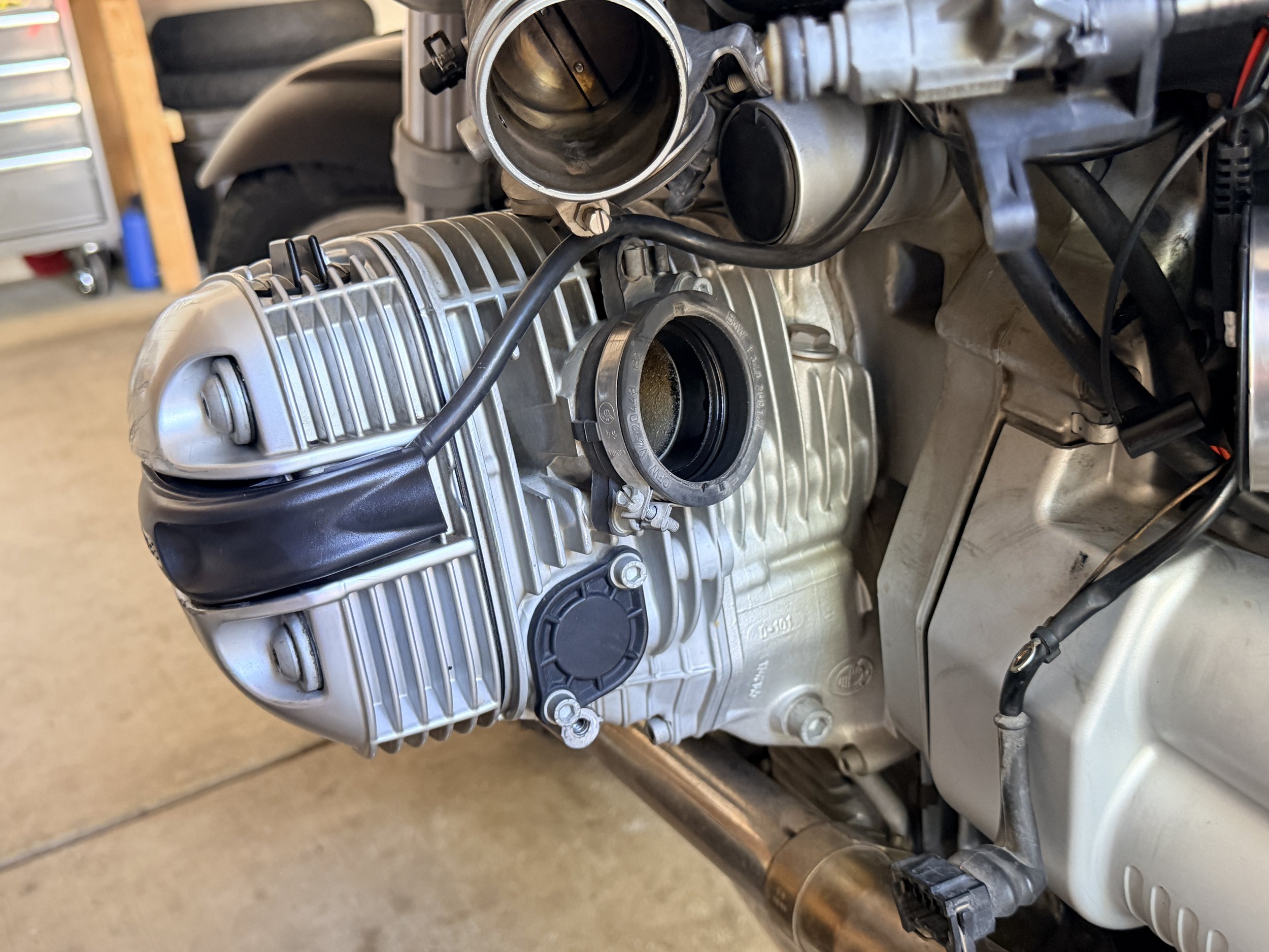 Removing the left throttle body to access the cam chain tensioner. 
