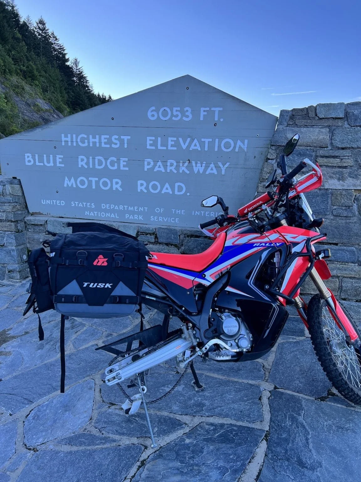 The author on a cross-country trip from Coastal North Carolina to his home in Northern Colorado. Fixing a flat on the Blue Ridge Parkway, a result of tire slippage that caused a valve stem tear. 