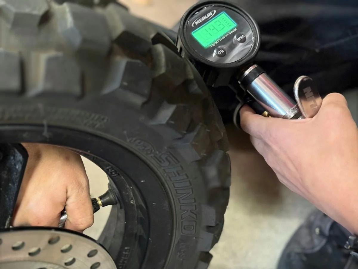 The author teaching his daughter how to check and adjust tire pressure with multiple different inflation methods on a 2024 CFMOTO Papio CL 125.