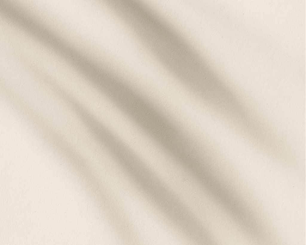 A beige wall with soft diagonal shadows.