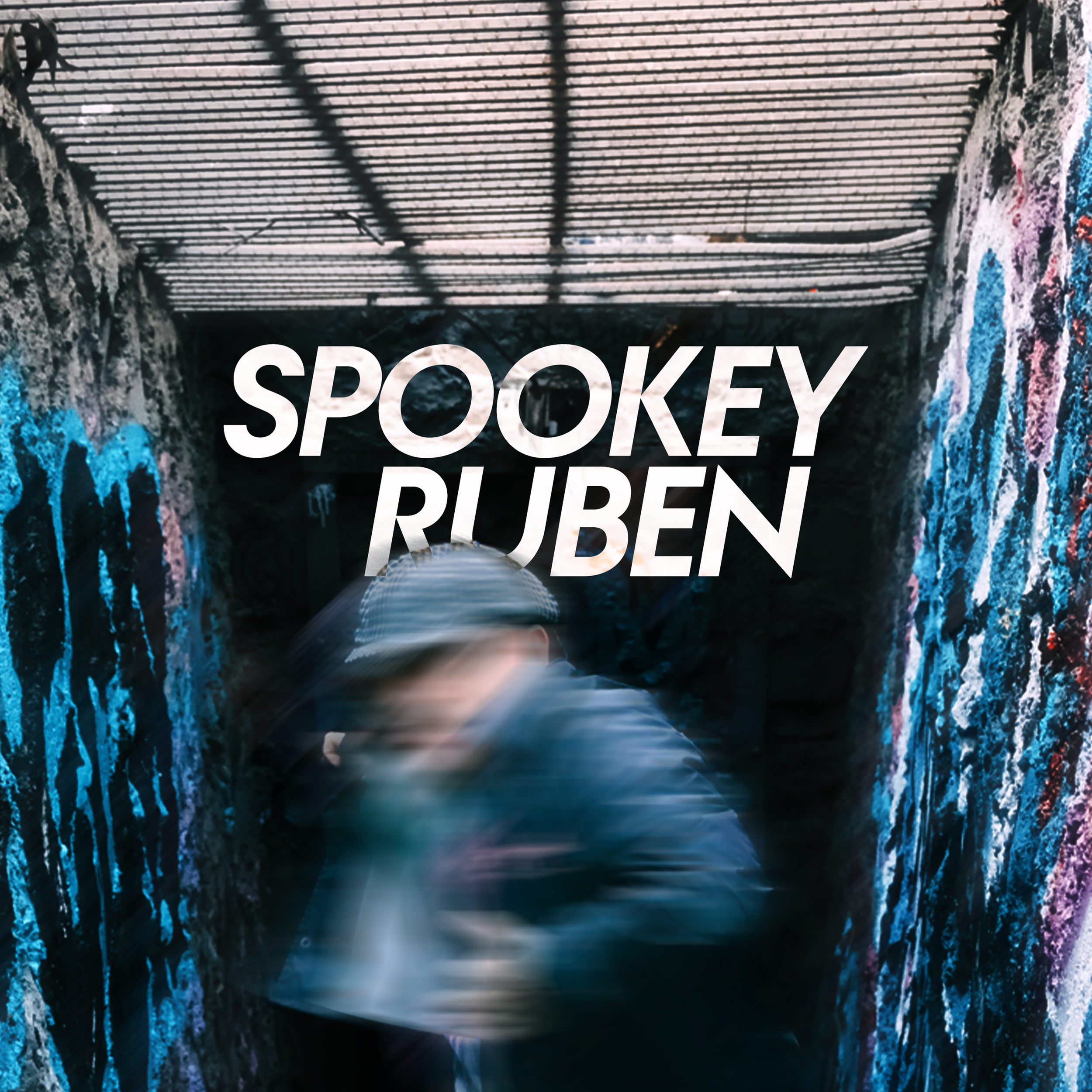 Motion-blurred image of Canadian artist Spookey Ruben moving over a dark underground tunnel with graffiti-covered walls.