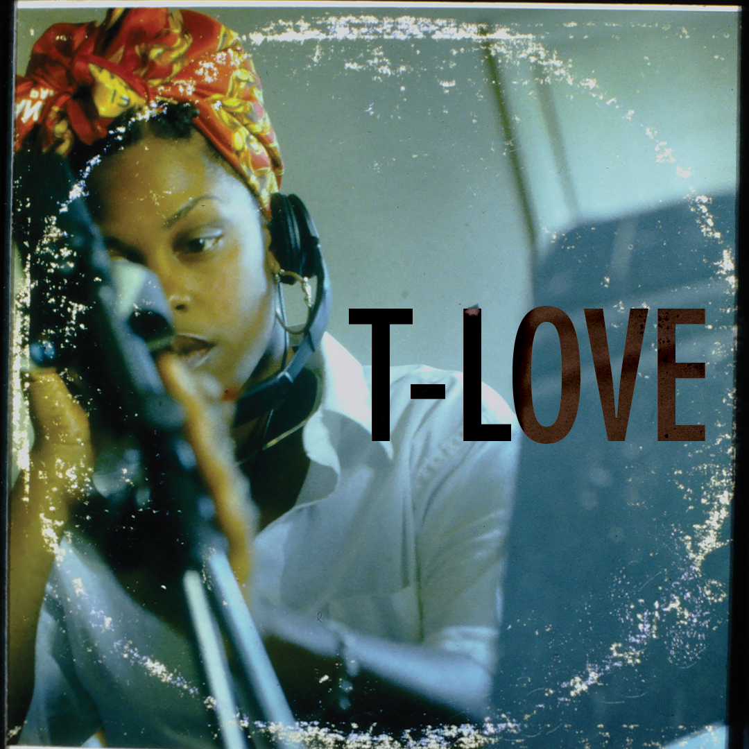 A close-up of LA-based artist T-Love with a red patterned headscarf, wearing headphones.