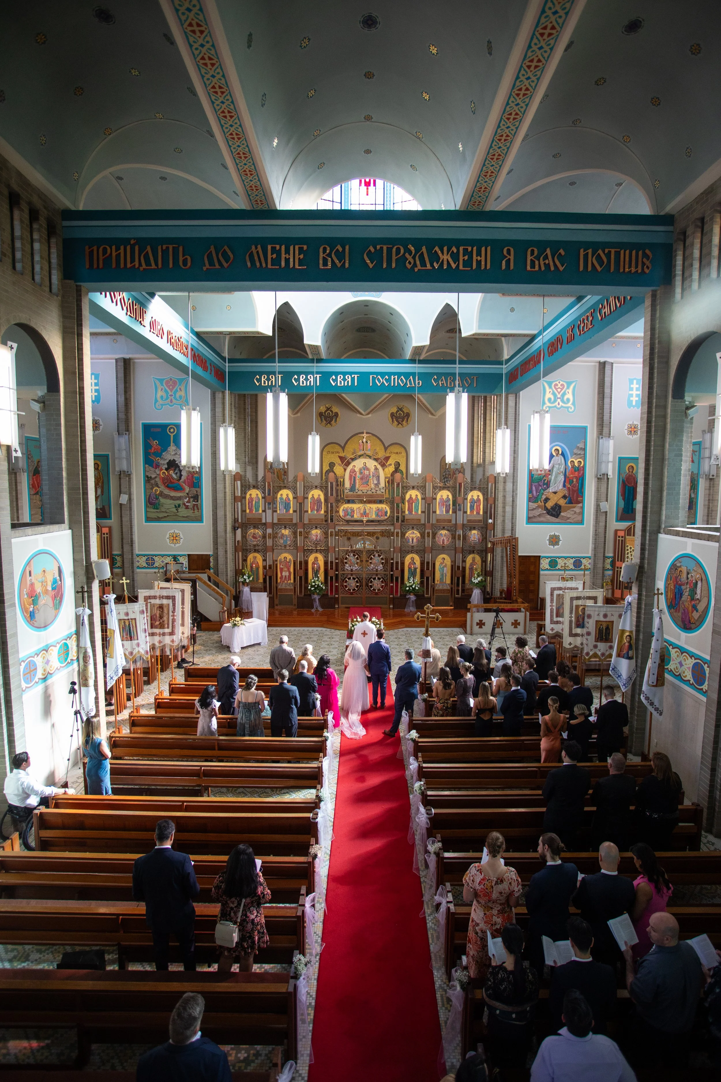 Abha & Andrew's Wedding walking out the church after getting married at Ukrainian Catholic Cathedral of Saints Peter and Paul