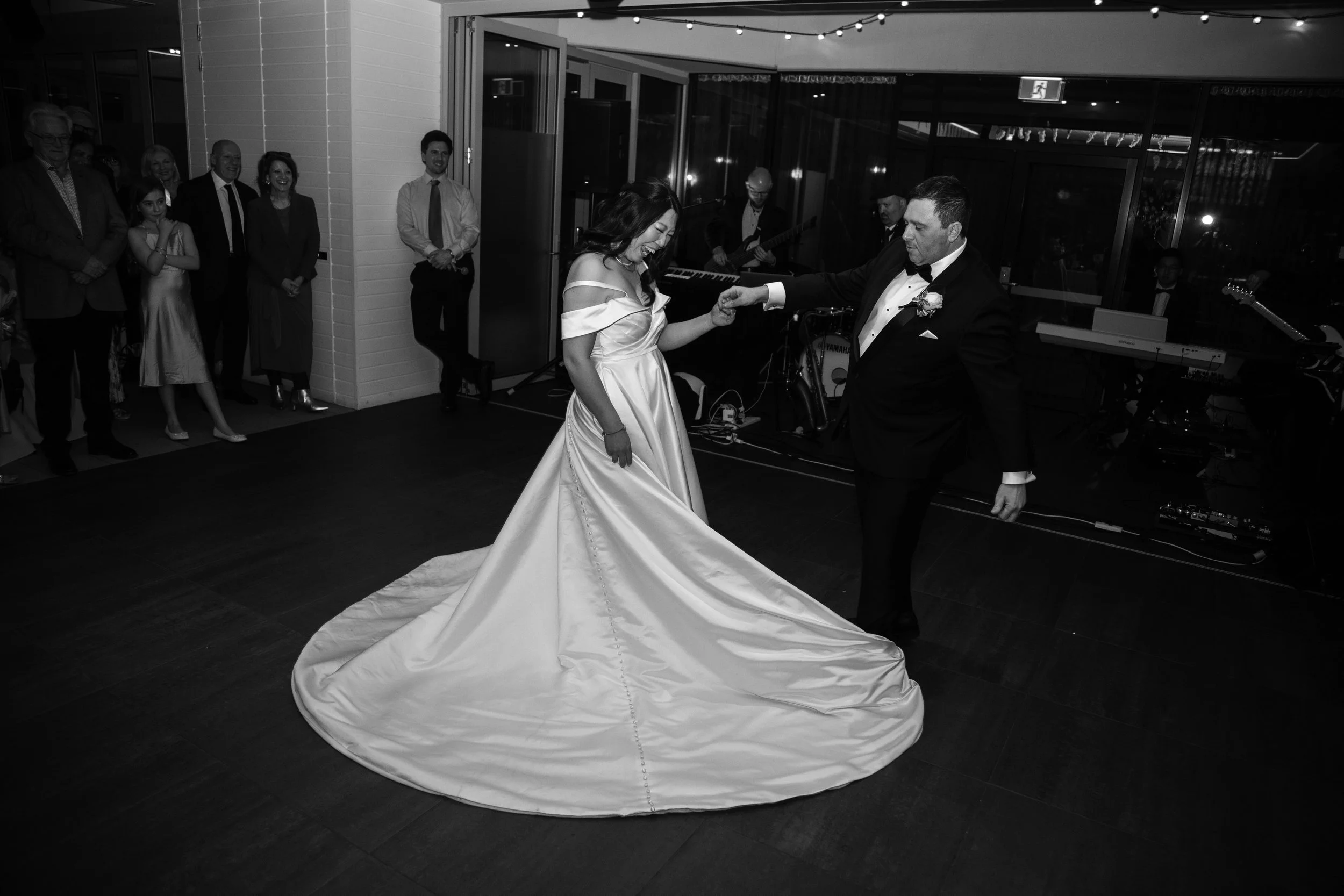 Jooah & David's kissing during their wedding photo shoot at Amora Hotel Riverwalk in Richmond