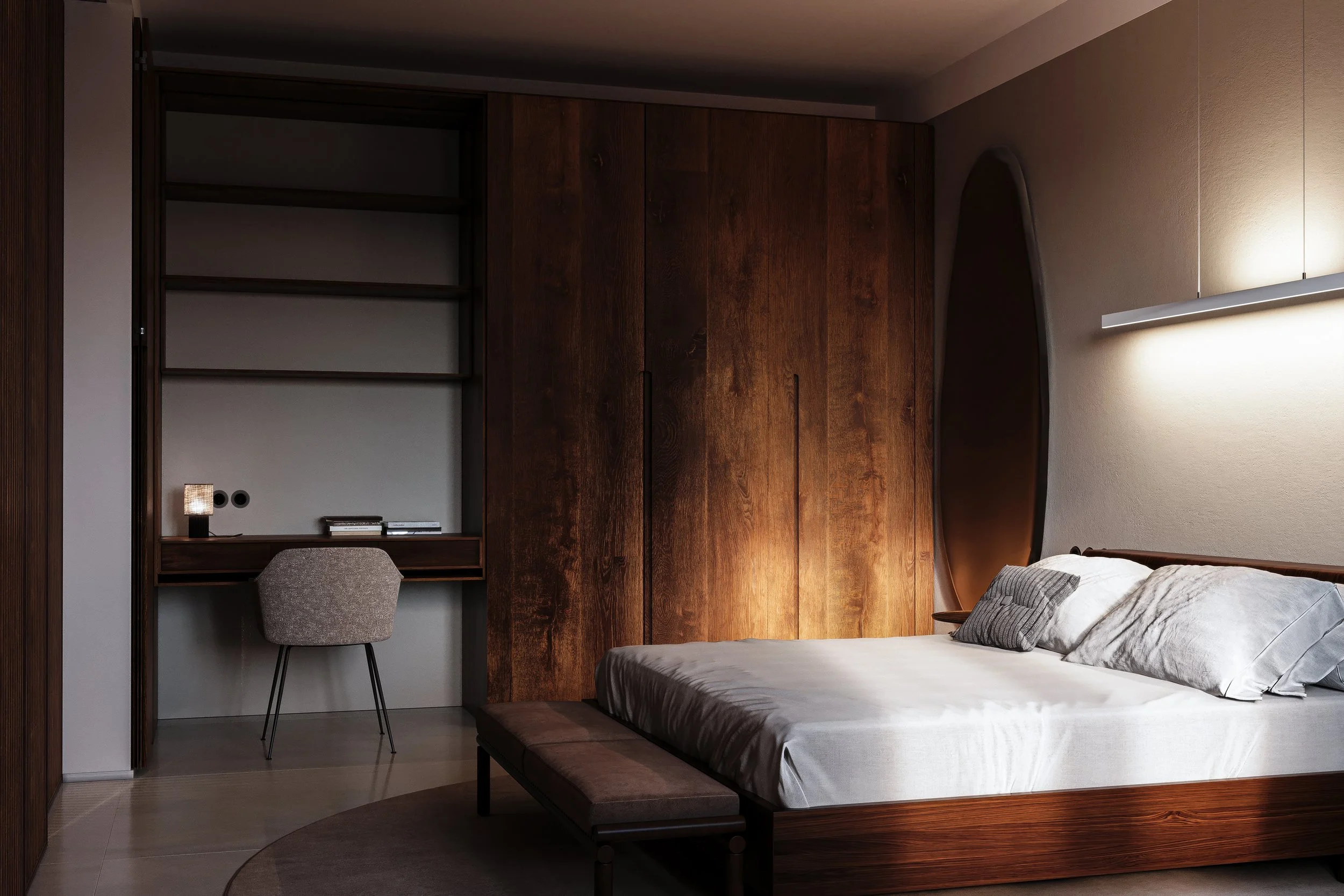 Modern bedroom with wooden furniture. Bed with gray sheets and pillows. Round mirror on the wall. Writing desk with a chair and books.