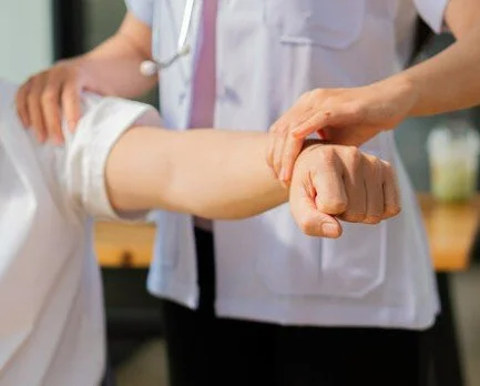 Applied kinesiology muscle strength testing on patient’s arm at The Nature of Health in Gilbert, AZ