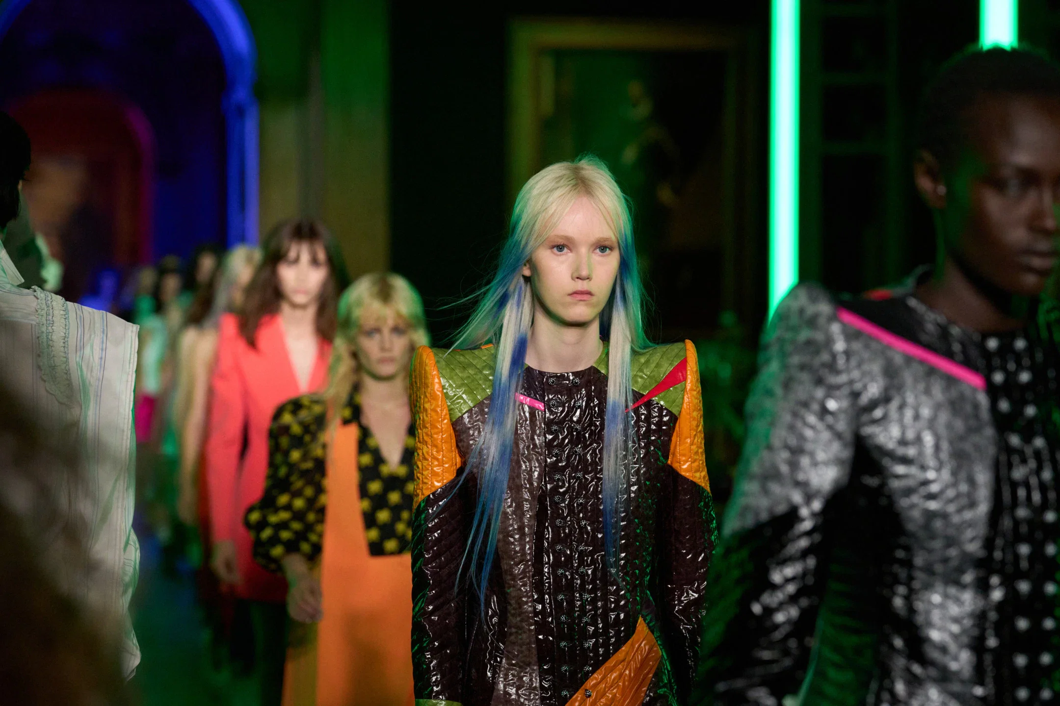 Models walking the runway lineup at the Louis Vuitton Cruise 2027 fashion show staged inside the dim, atmospheric gallery spaces of the Frick Collection.