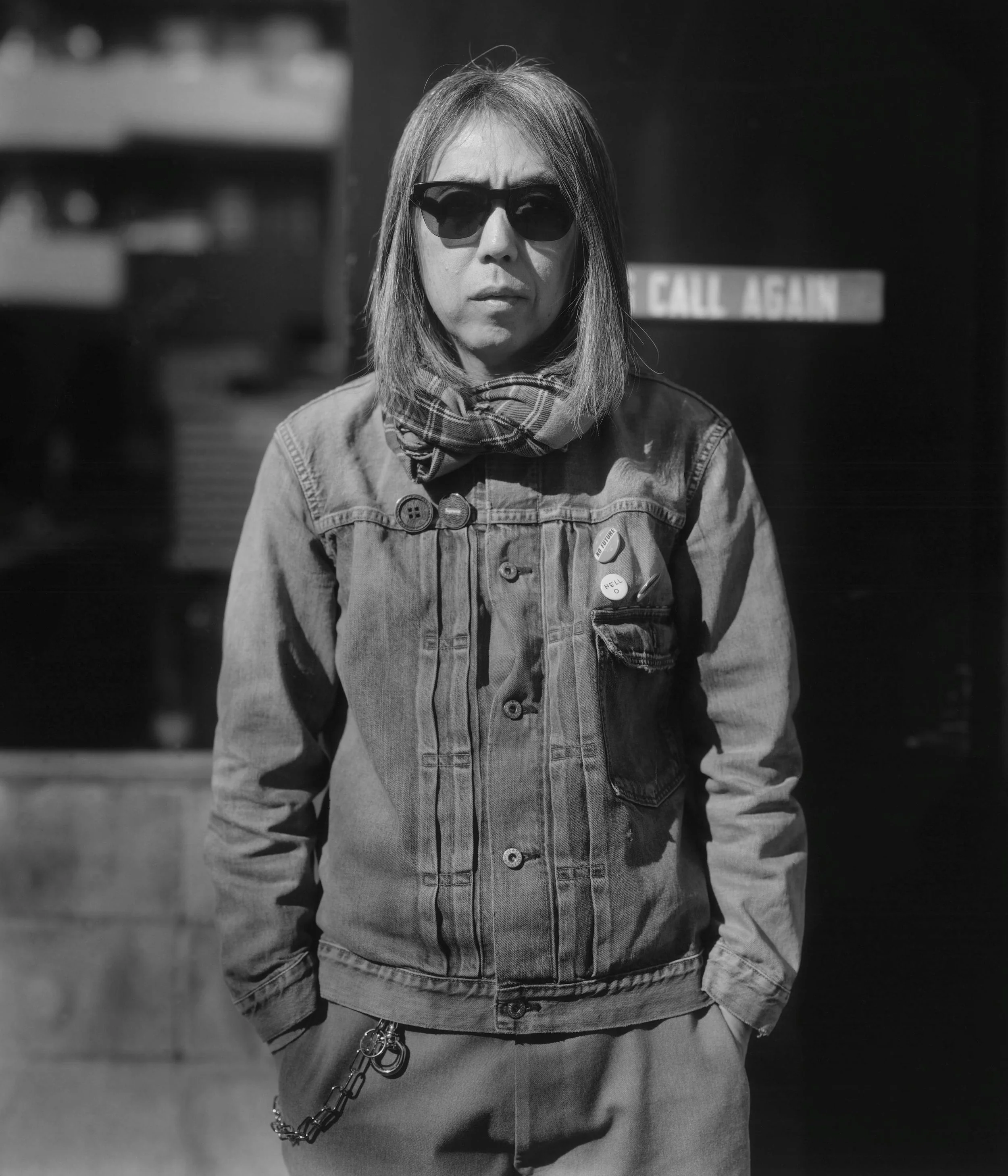 A black and white portrait of streetwear designer and musician Hiroshi Fujiwara, embodying the PLCFA concept of the 'Creator as Philosophical Architect'.