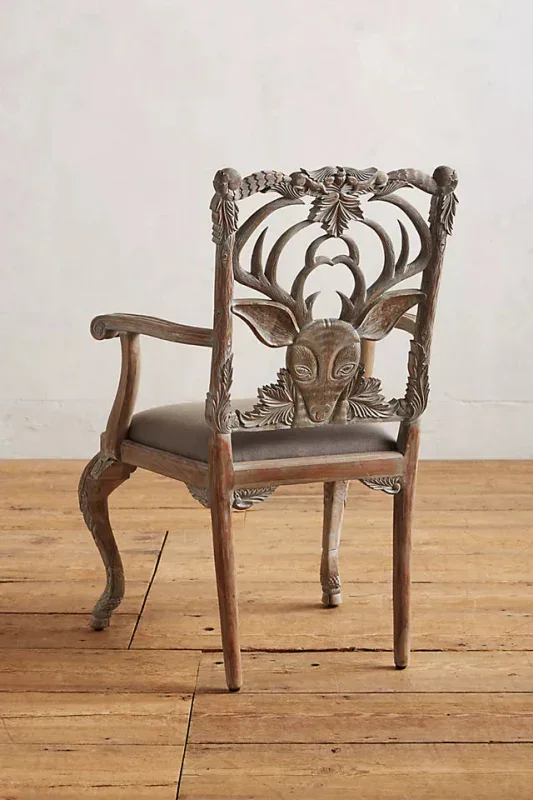An artisan hand-carved wooden armchair, representing the 'Centennial Chair' case study, showcasing traditional joinery and a design philosophy of permanence and narrative.
