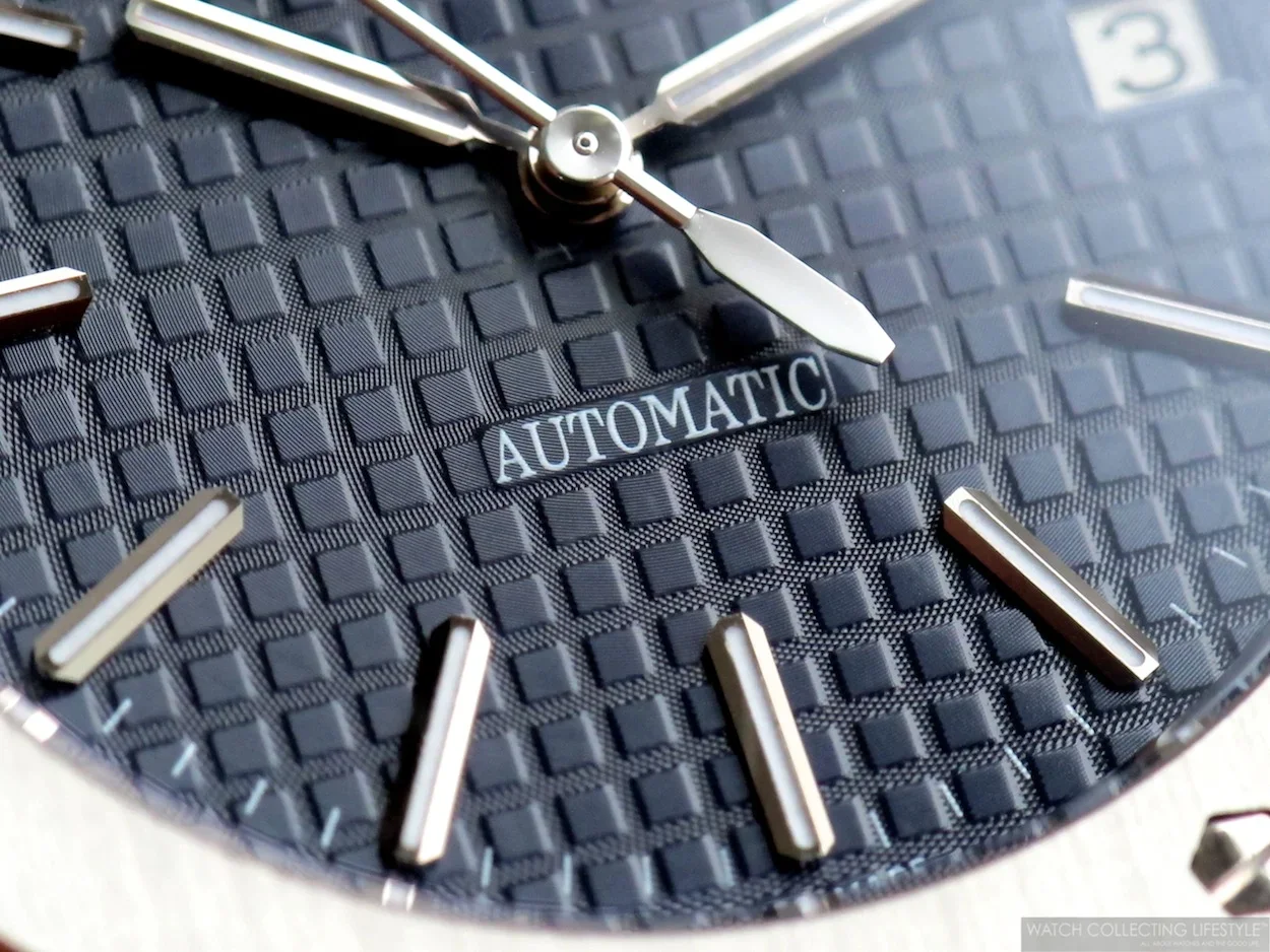 Close-up of an original Audemars Piguet Royal Oak luxury wristwatch in stainless steel, featuring the iconic navy blue Grande Tapisserie dial, integrated bracelet, and octagonal bezel with exposed screws.