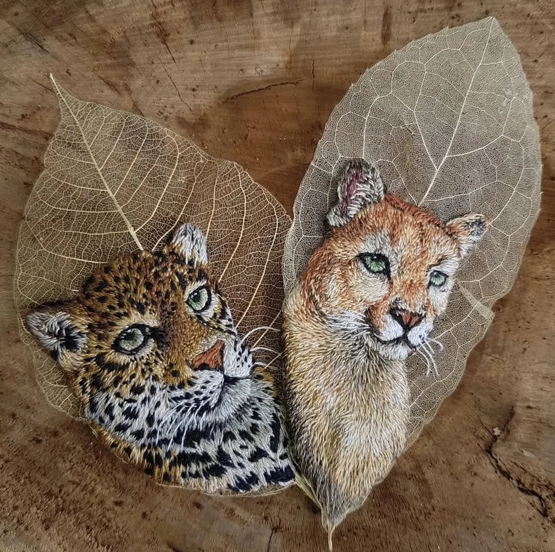 Close up of two skeletonized leaves embroidered with the detailed heads of a Jaguar cub and a Puma, illustrating Alan Vilar’s Post Luxury Conceptual Functional Art (P.L.C.F.A.) and Deep Materiality.