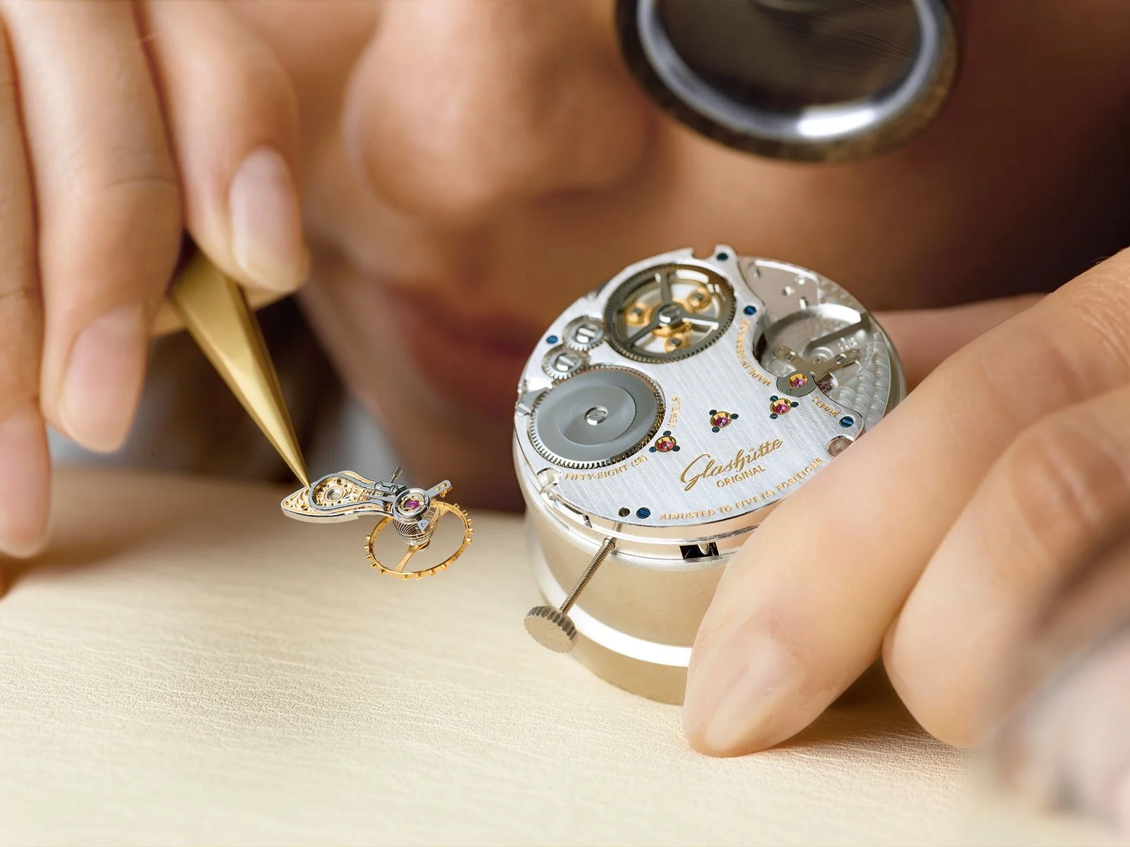 A close-up of a skilled artisan watchmaker, wearing an eye loupe, meticulously assembling delicate components of a mechanical watch movement with tweezers, symbolizing dedication to traditional craftsmanship and quality.