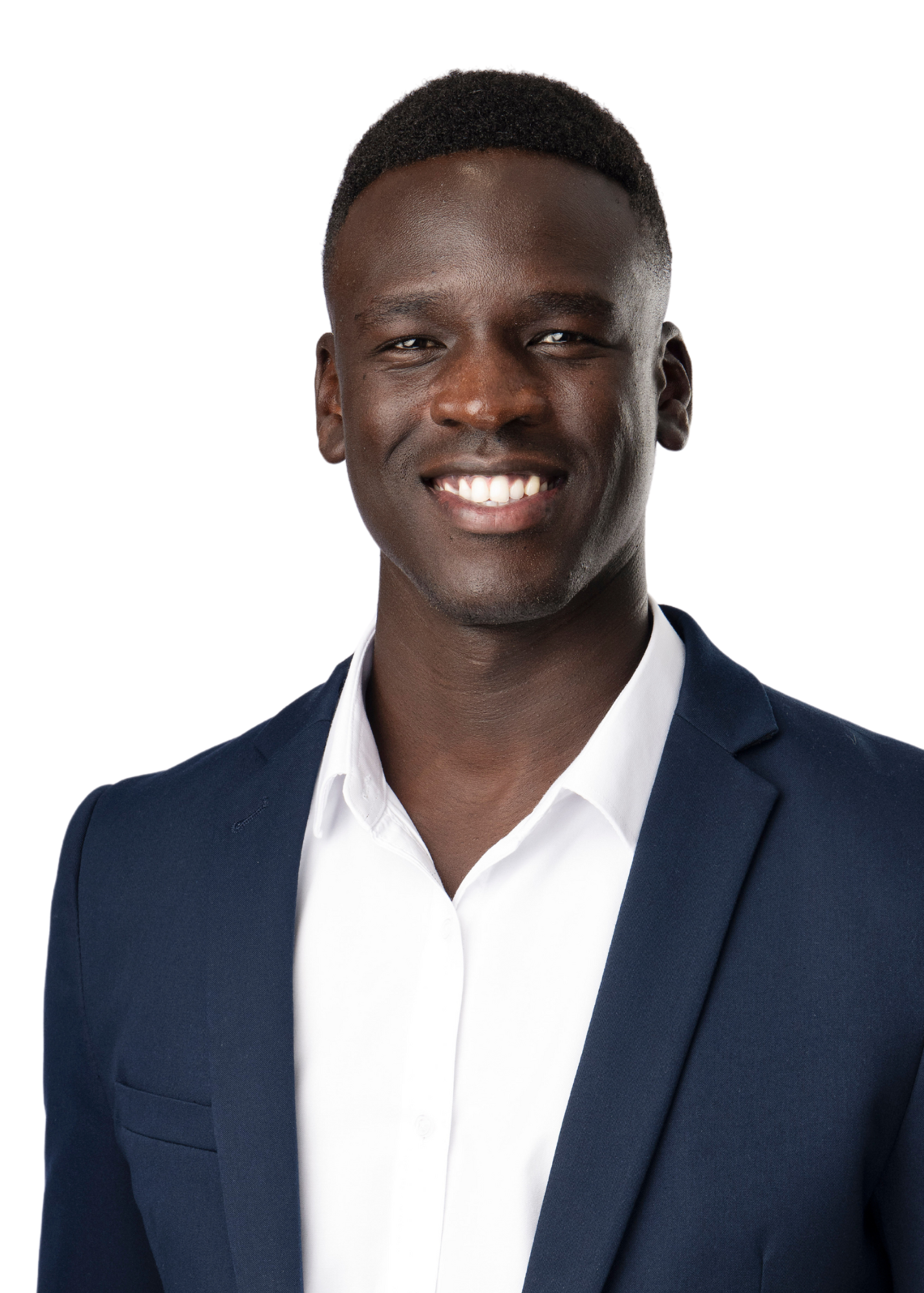 Portrait of a young African American man in a navy suit and white shirt, smiling with teeth showing, against a plain white background.