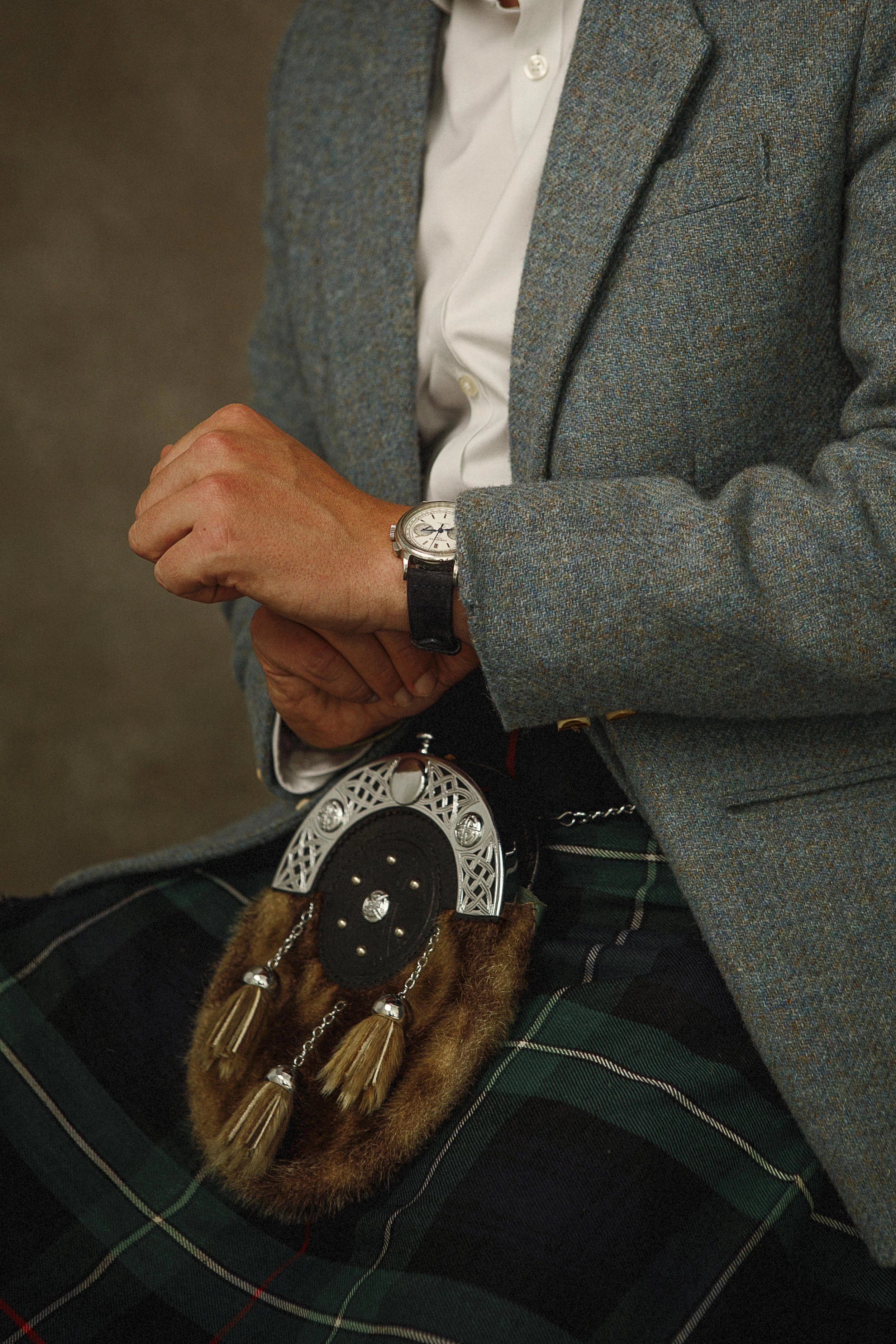 Close-up portrait detail, traditional Scottish kilt tartan and fabric texture, editorial photography