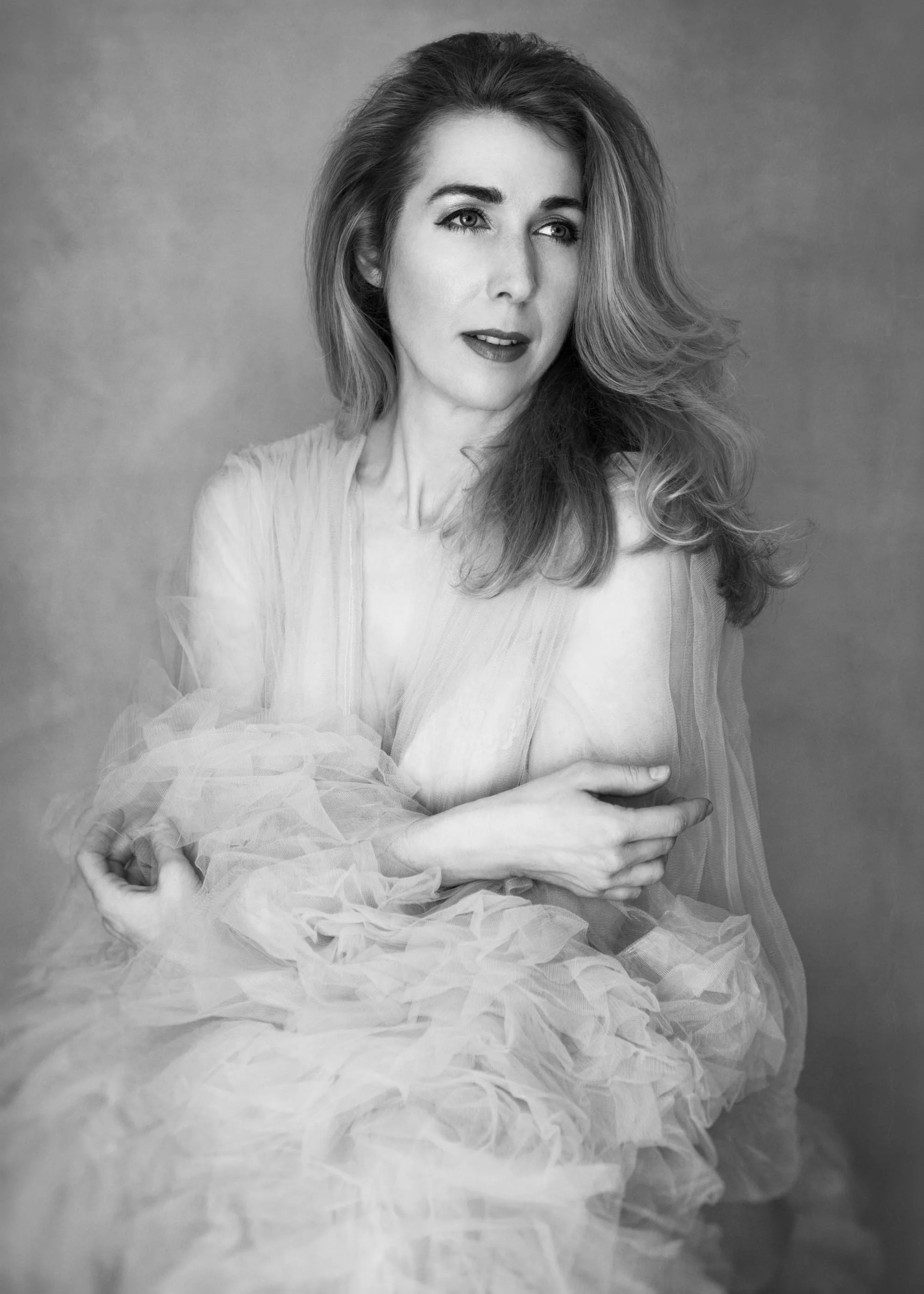 woman in a tulle robe photographed in black and white style