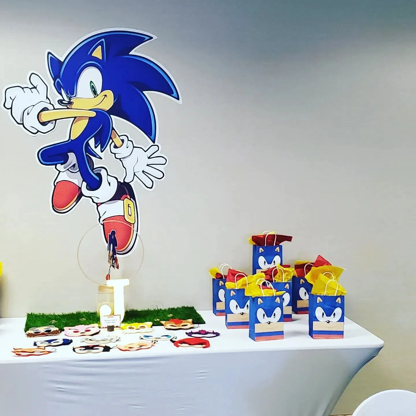 Sonic the Hedgehog themed birthday party table with Sonic character cutouts, gift boxes, and decorations.