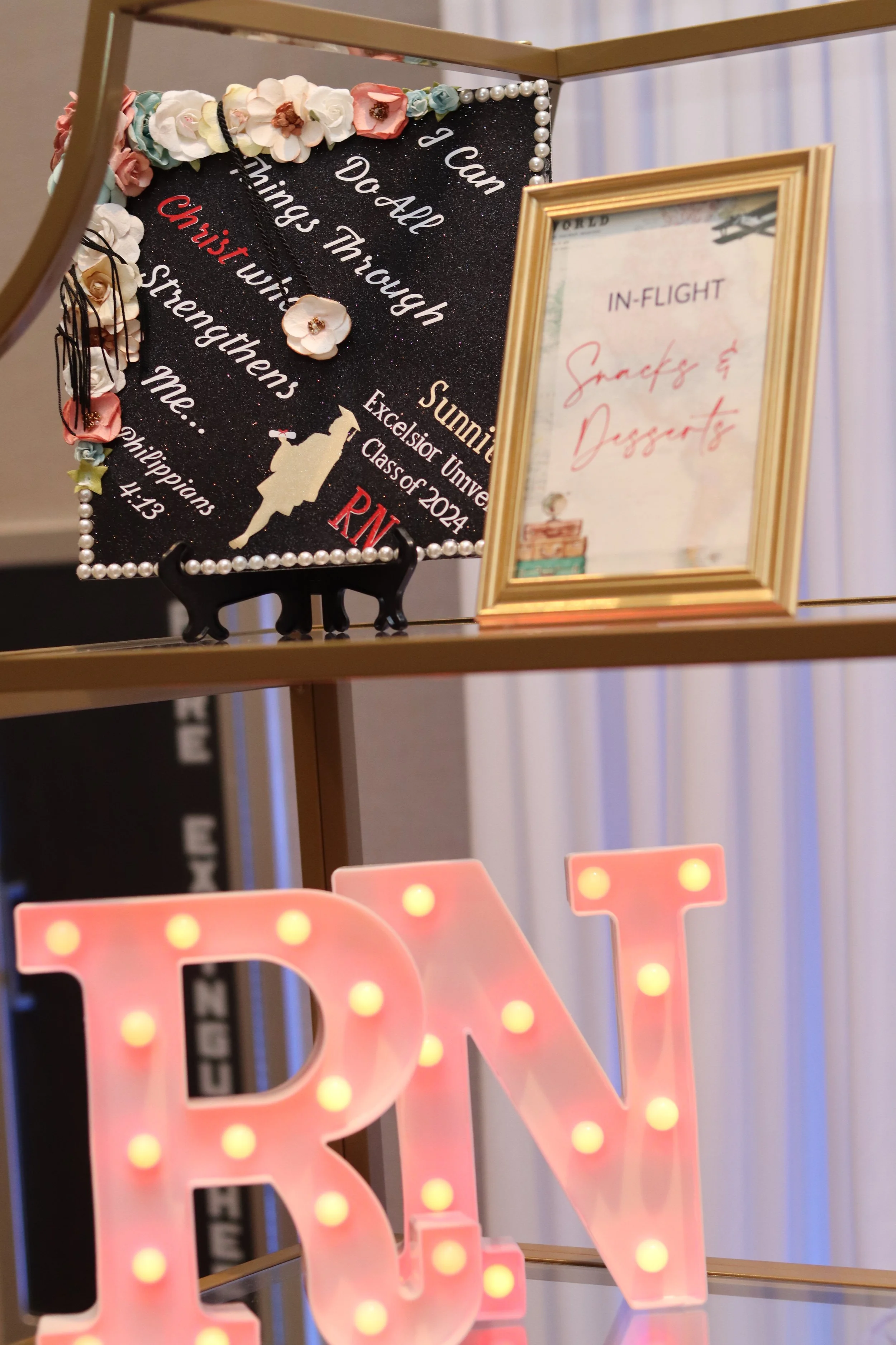 Decorative display with a blackboard sign that reads 'I can Dad all things through' with decorative flowers and soap bubbles, a framed sign that says 'Snacks & Dips', and a marquee letter 'R'.