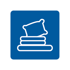 Icon of a pillow resting on a stack of three books, all outlined in white on a blue background.