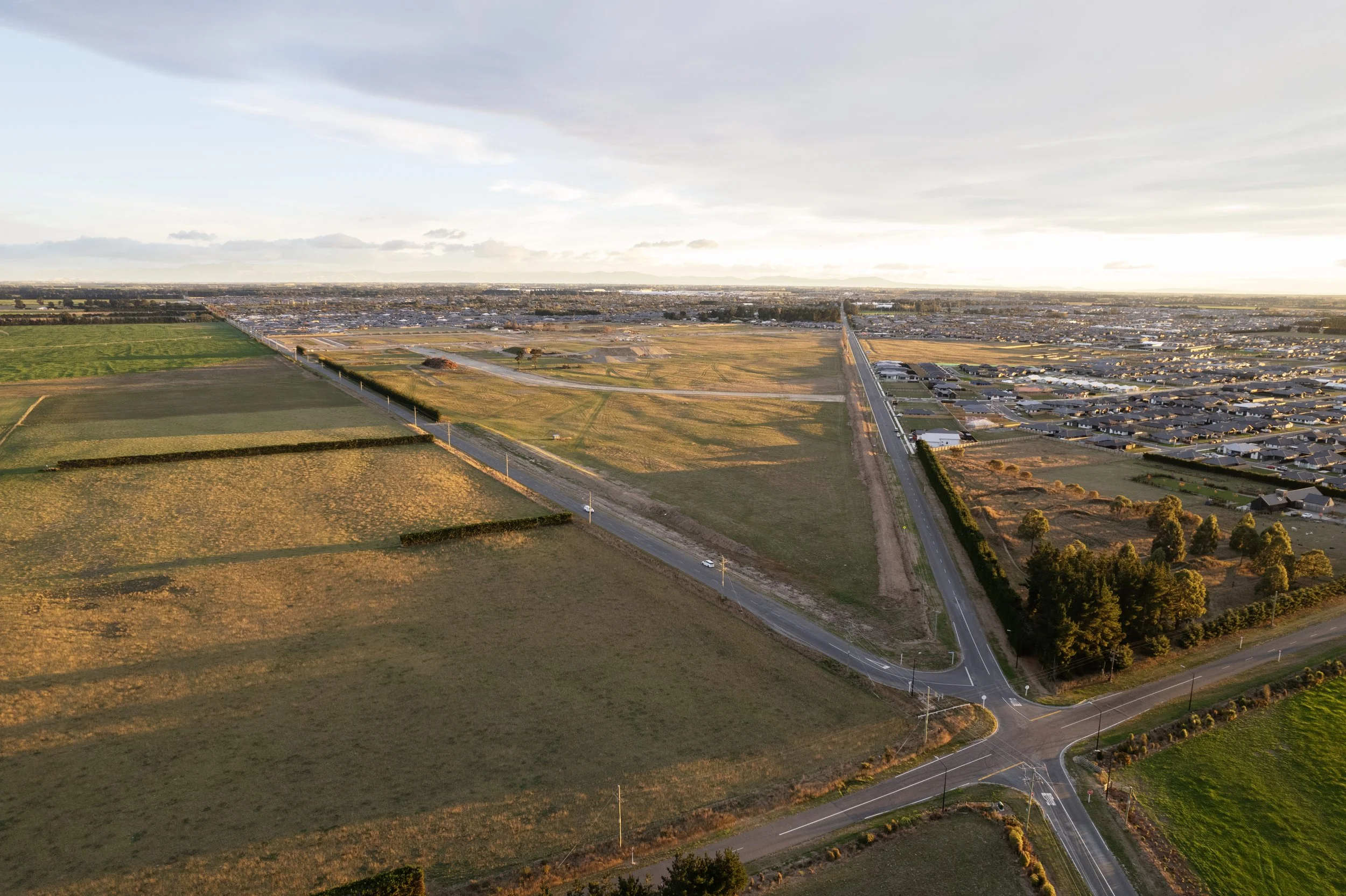 Aerial before-render view of Arbor Green site showing raw subdivision layout and undeveloped lots