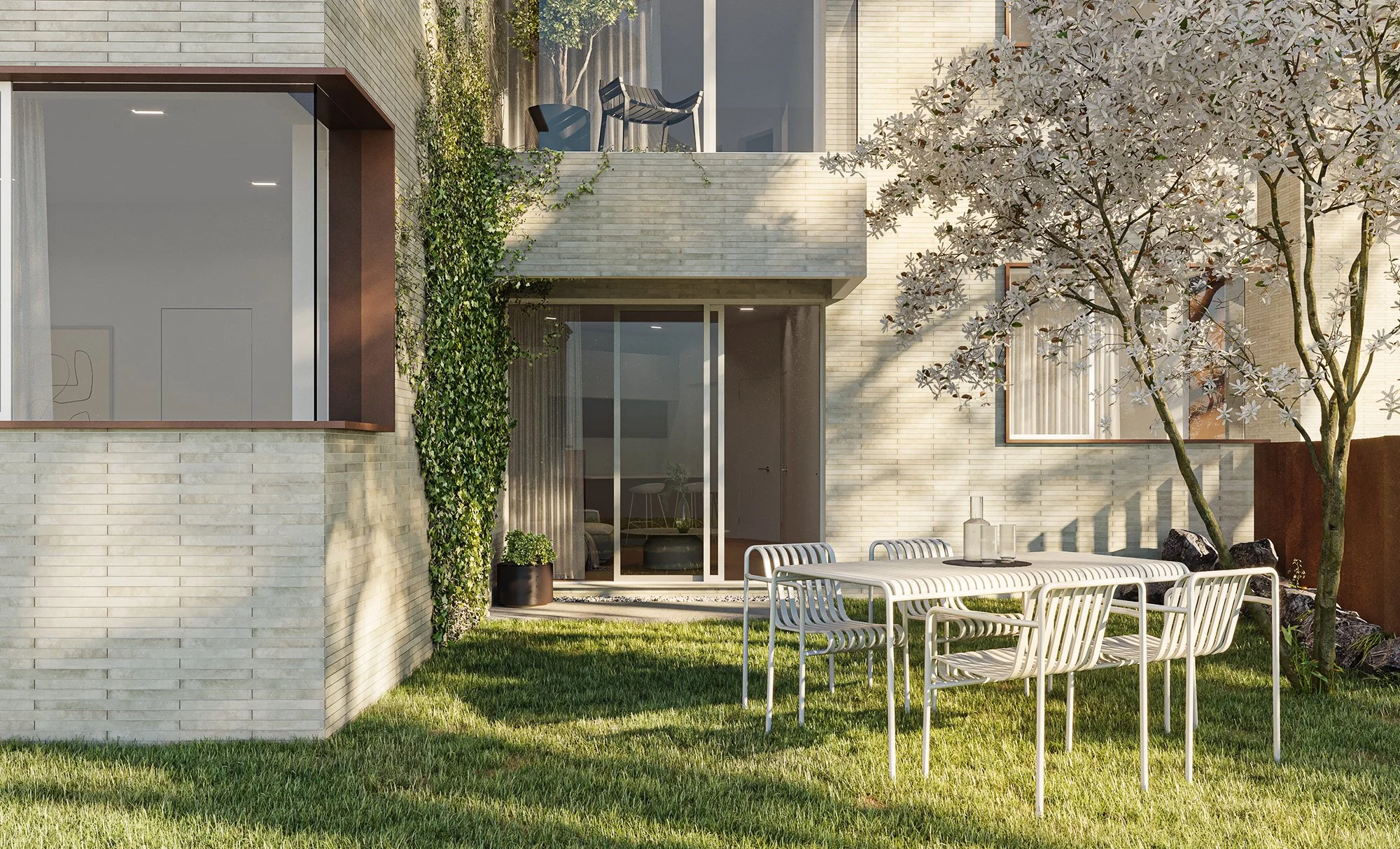Endo Apartments 앞마당의 휴식 공간과 저층부 외벽이 어우러진 외관 장면