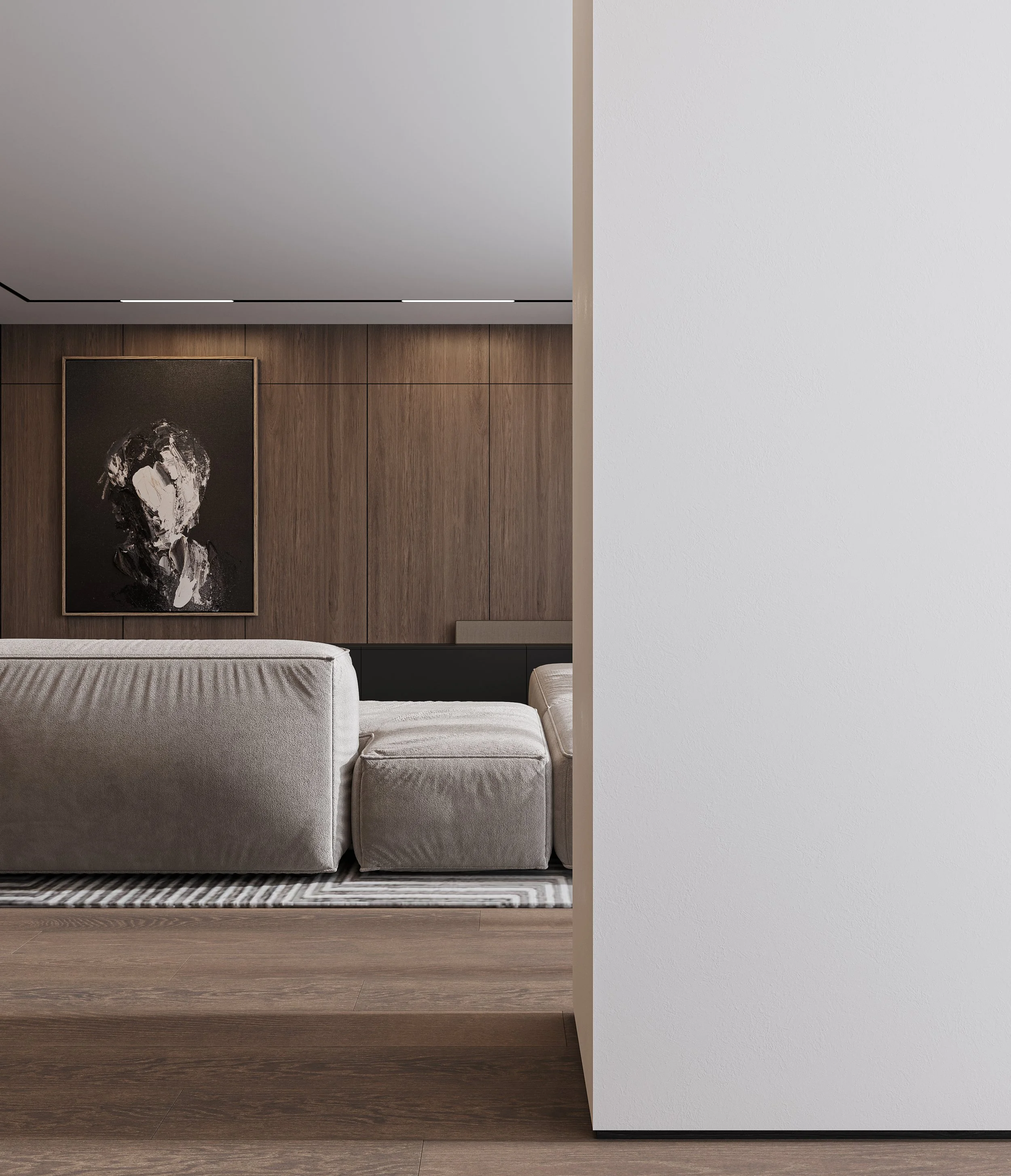 Living room with lounge furniture, textured rug, and soft natural lighting from large glazing