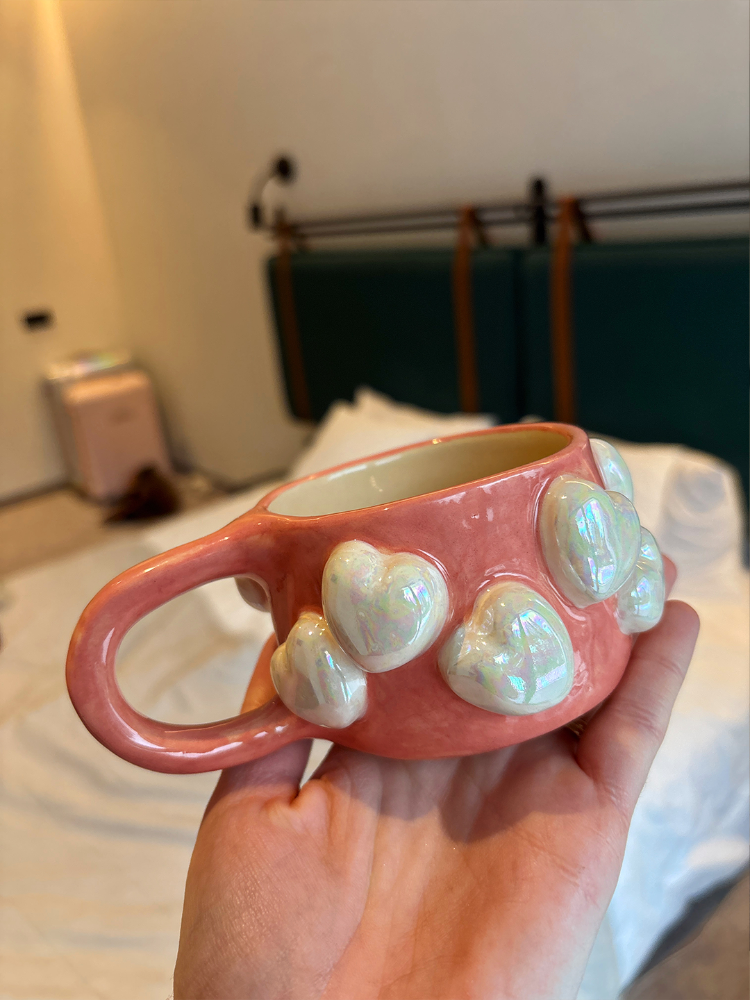 A pink pearlescent mug with hearts