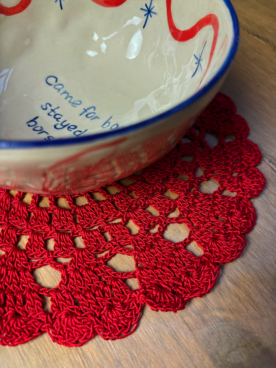 Hand-crocheted red table mat
