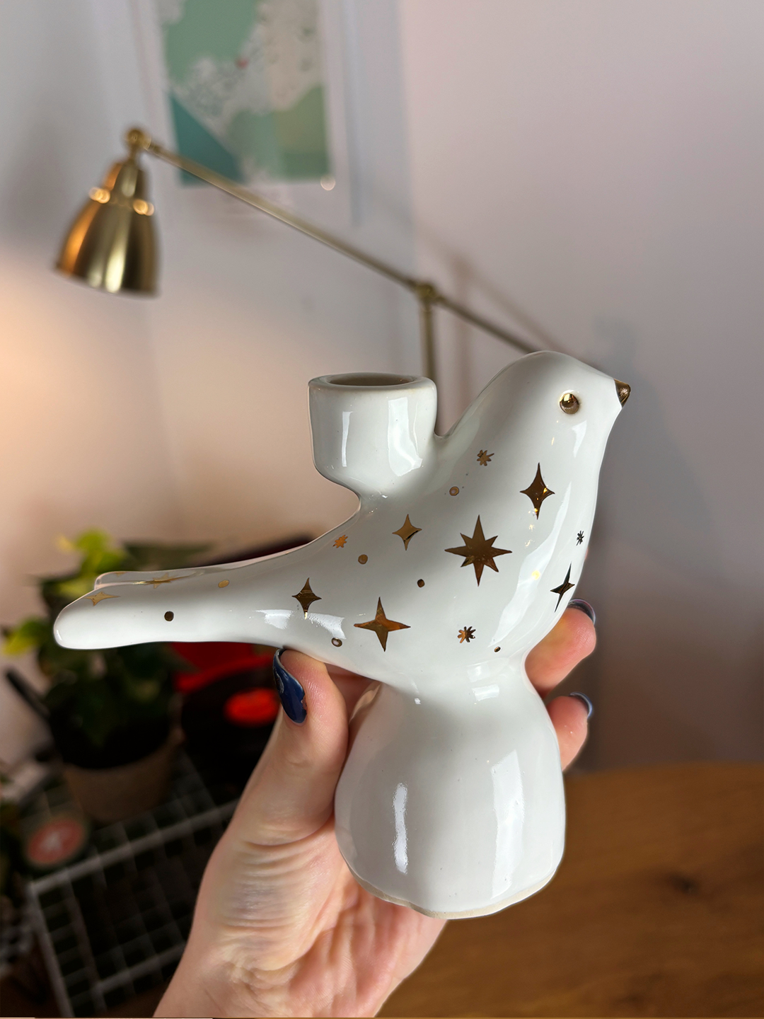 white candle holdes golden stars.png