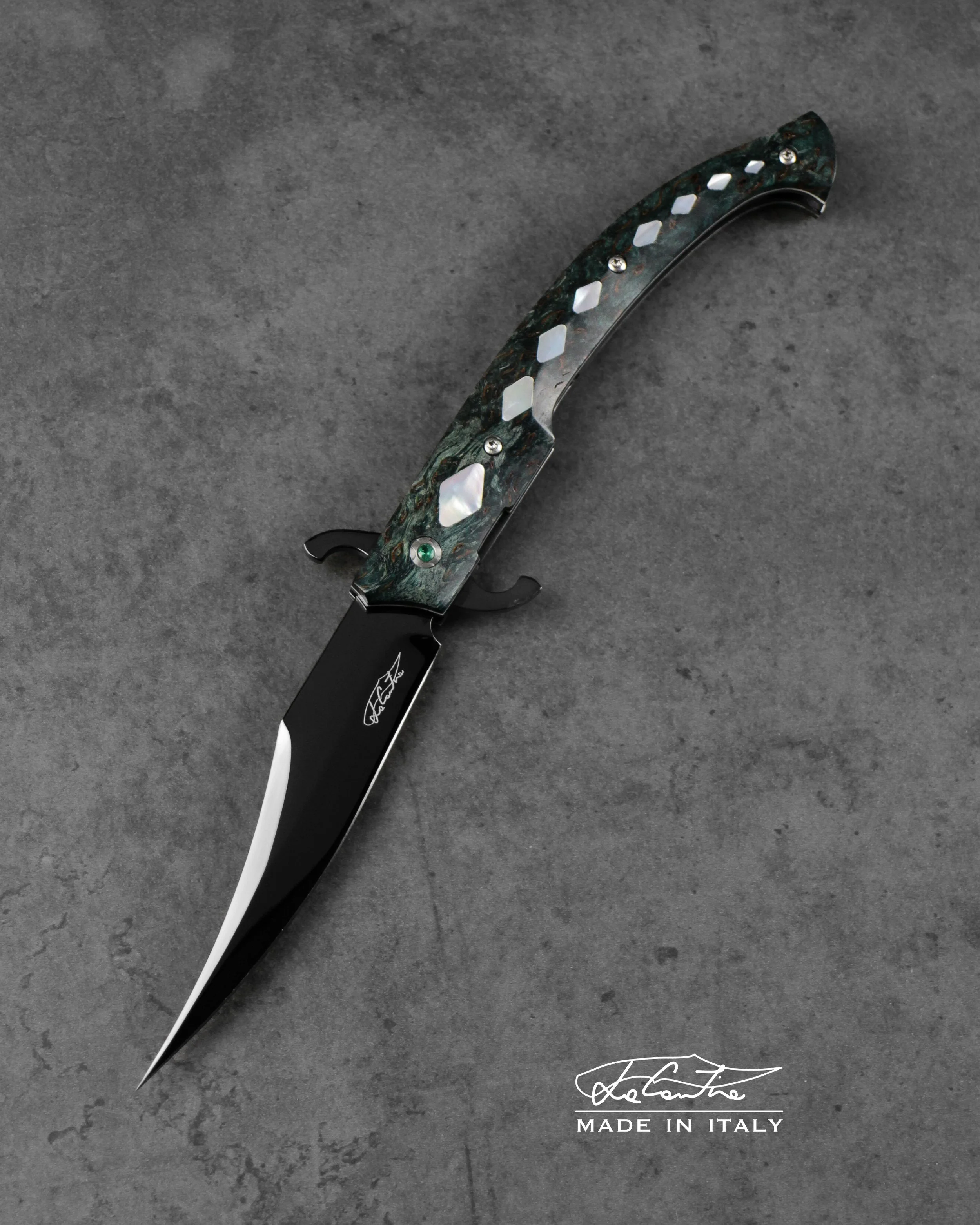BLADE: RWL34 with DLC treatment. 
HANDLE: Stabilized Birch, Mother of pearl inlays, mechanics with hardened steel and DLC coating, white G10, carbon spacer, emerald stones
