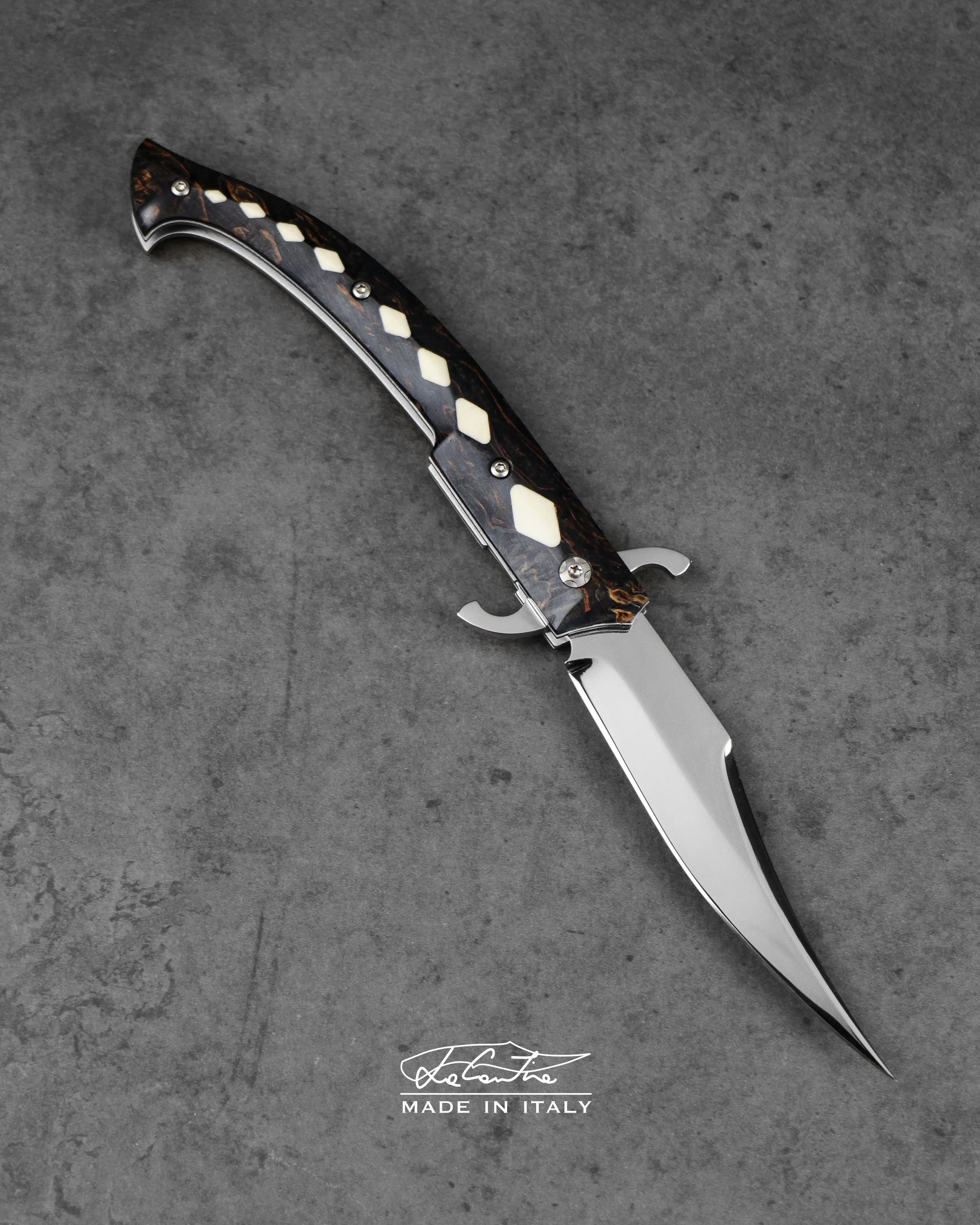 BLADE: RWL34. 
HANDLE: Stabilized Birch, Mammoth tusk inlays, mechanics with hardened steel, white G10, carbon spacer.