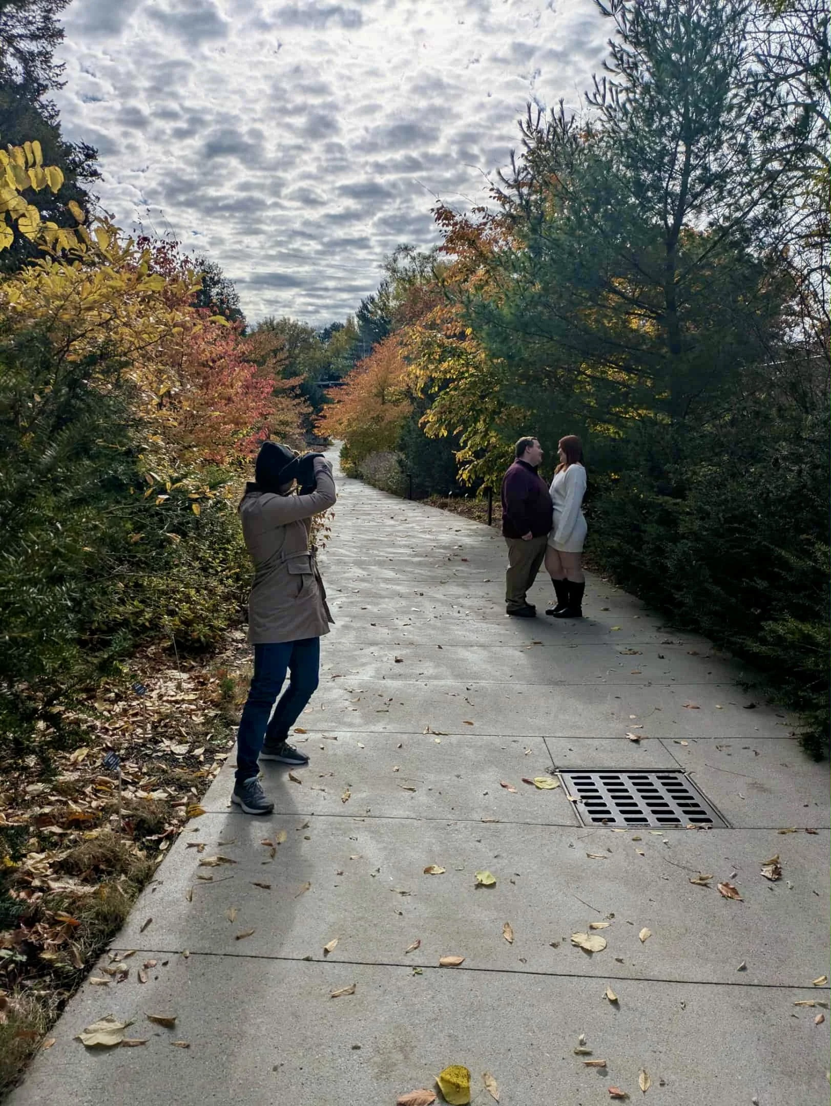 Photographer capturing a couple on their wedding day in a garden
