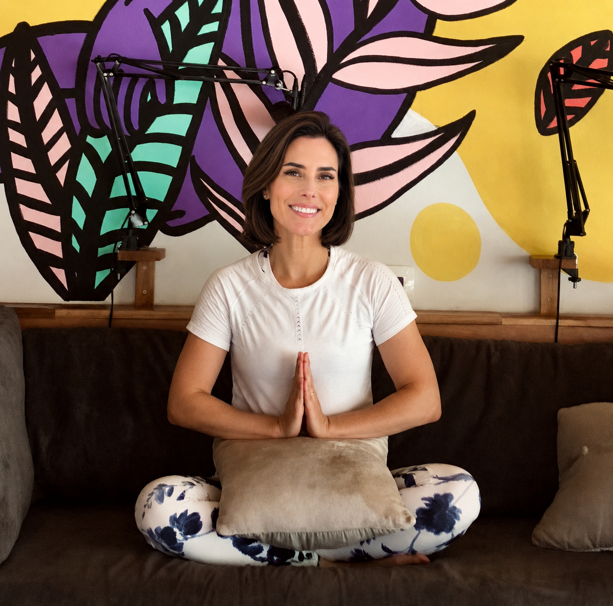 Nerissa Balland in Costa Rico in front of colorful abstract artwork during yoga retreat.